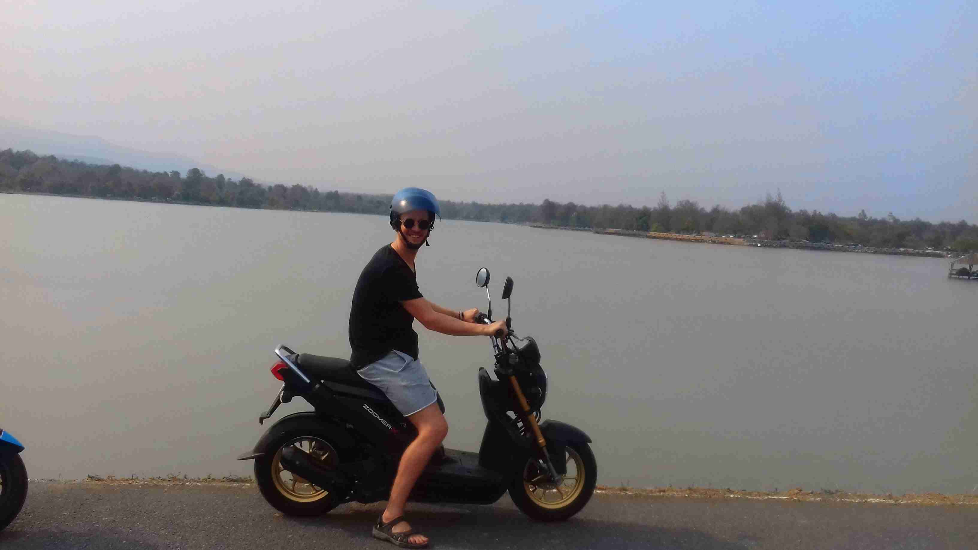 Mark on a scooter overlooking a body of water.