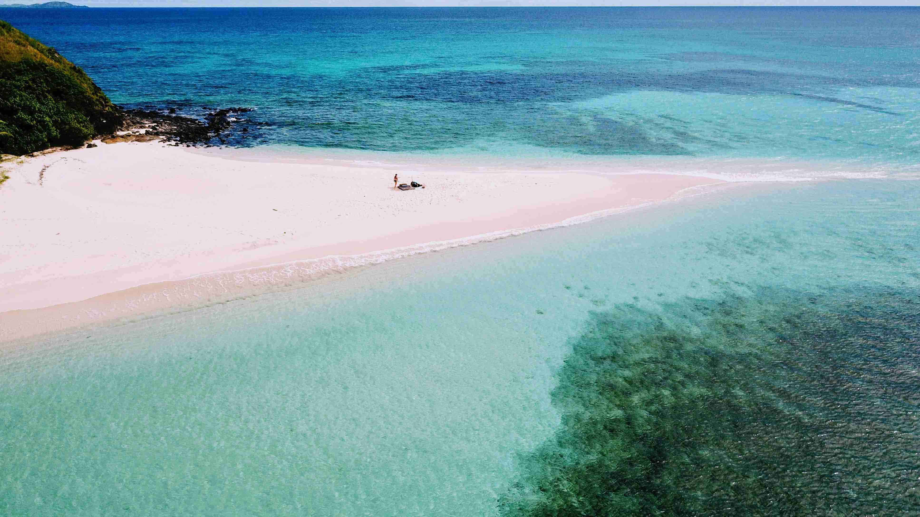 Aerial View of People on Sandy Beach with Clear Waters