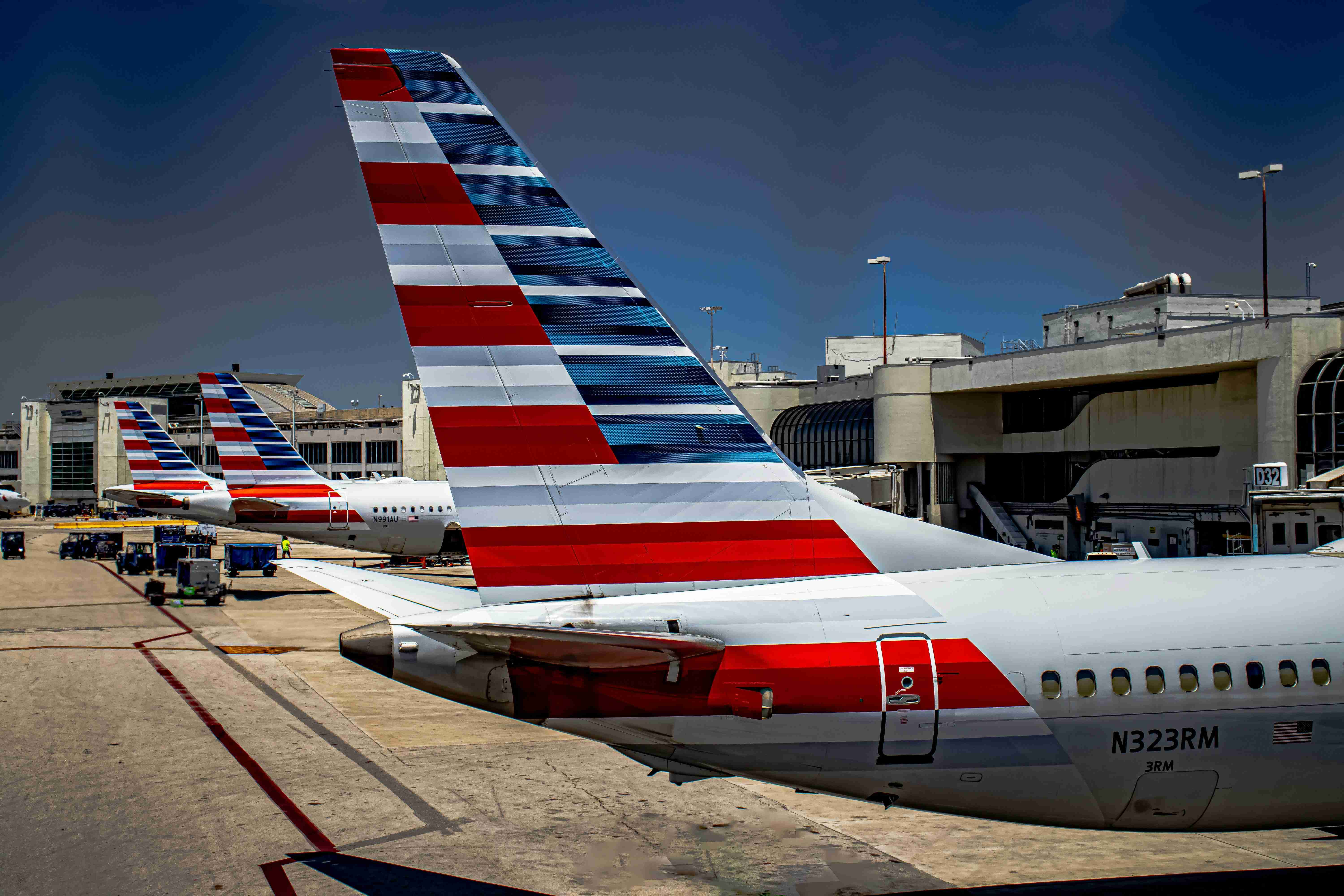 Airline Tails Lined Up At Airport Gate