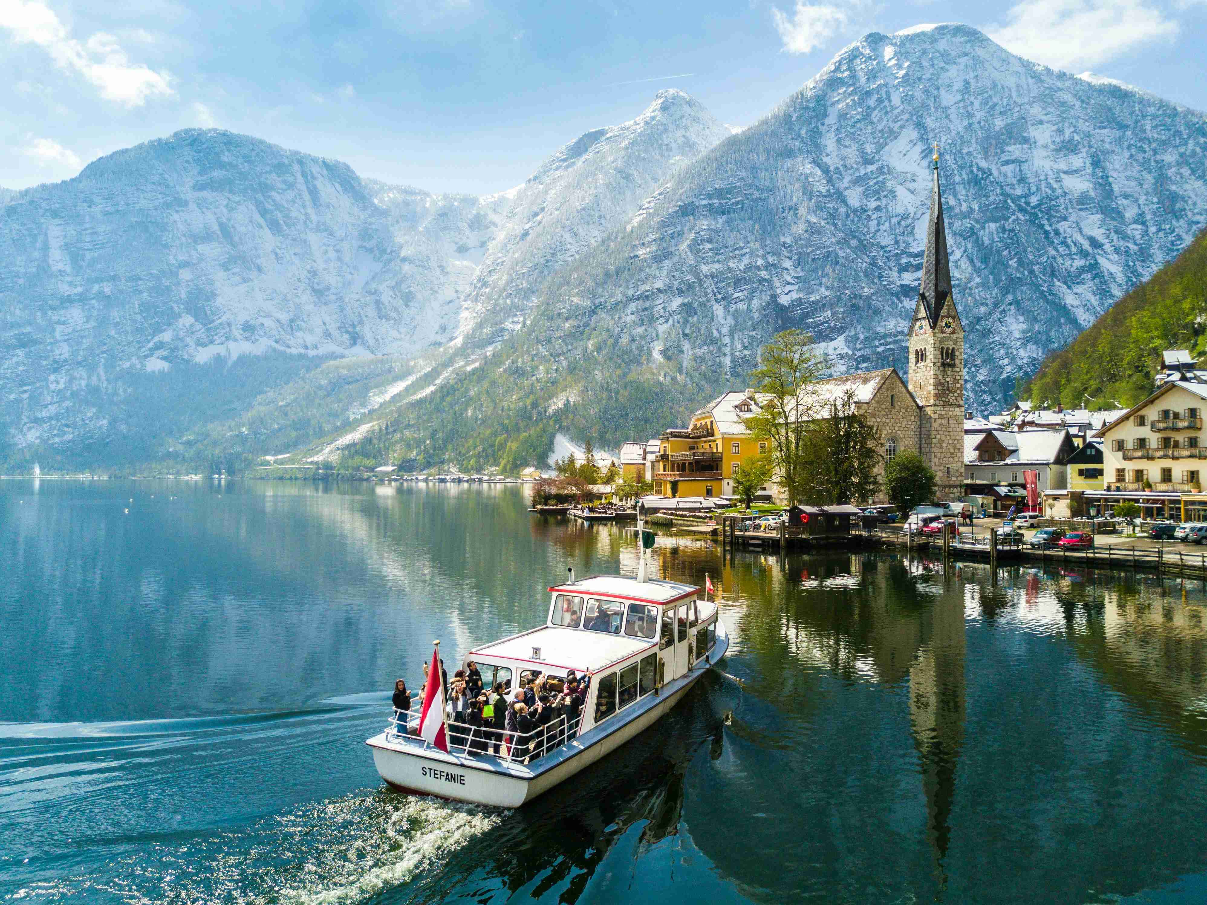 Alpine Village with Church and Boat on Lake