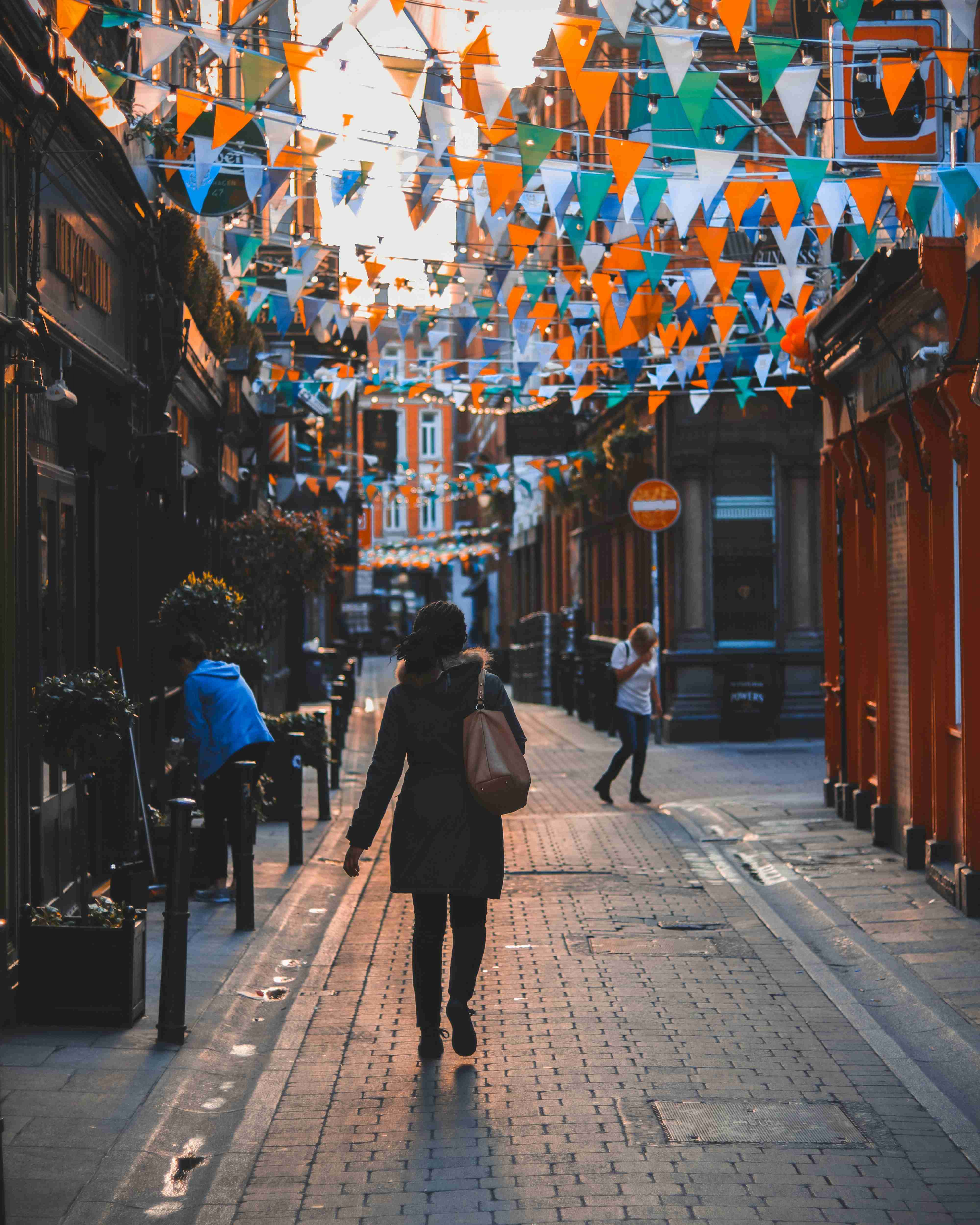 Festive Flagged Alleyway with Pedestrian