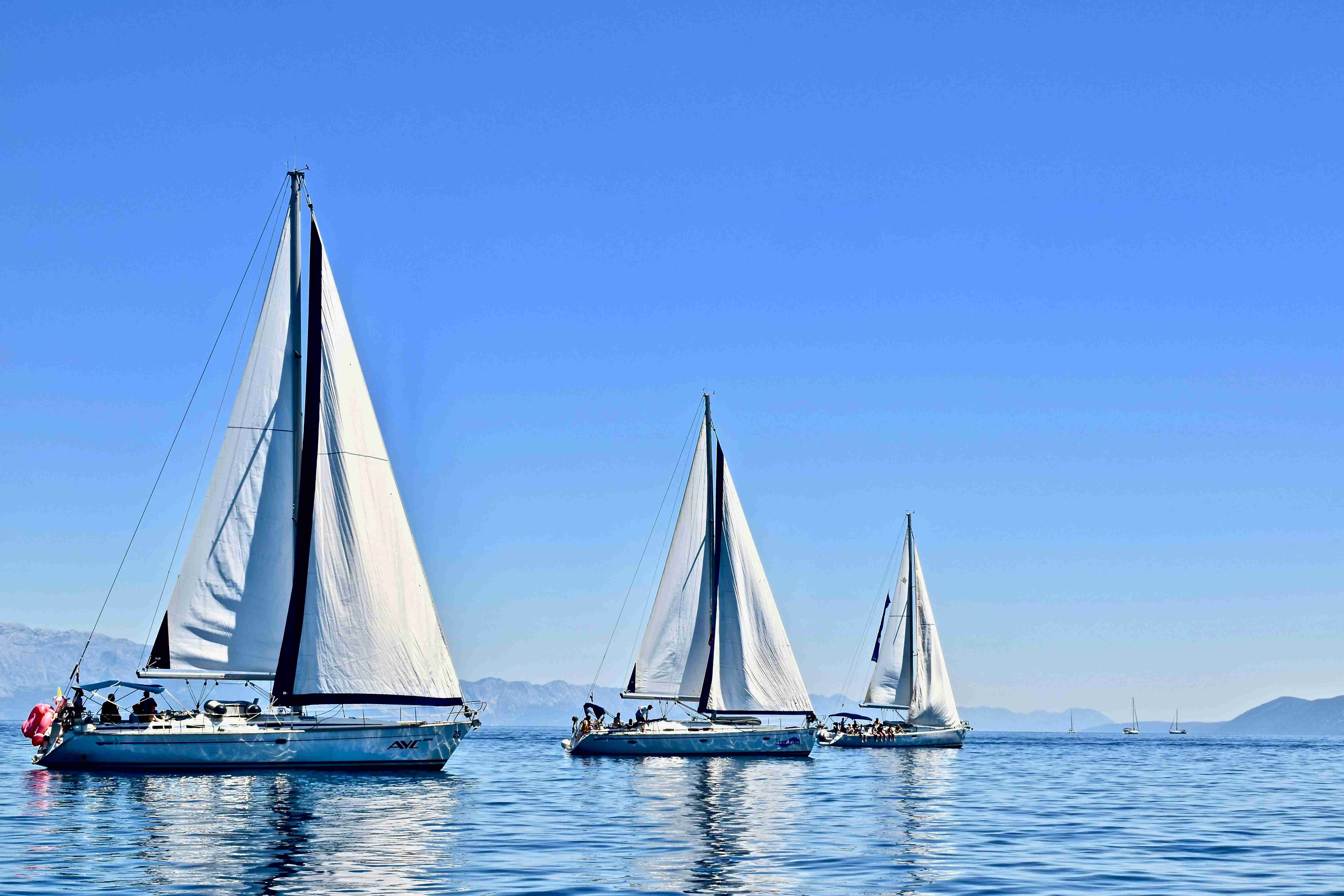 Sailing Trio on Calm Blue Waters