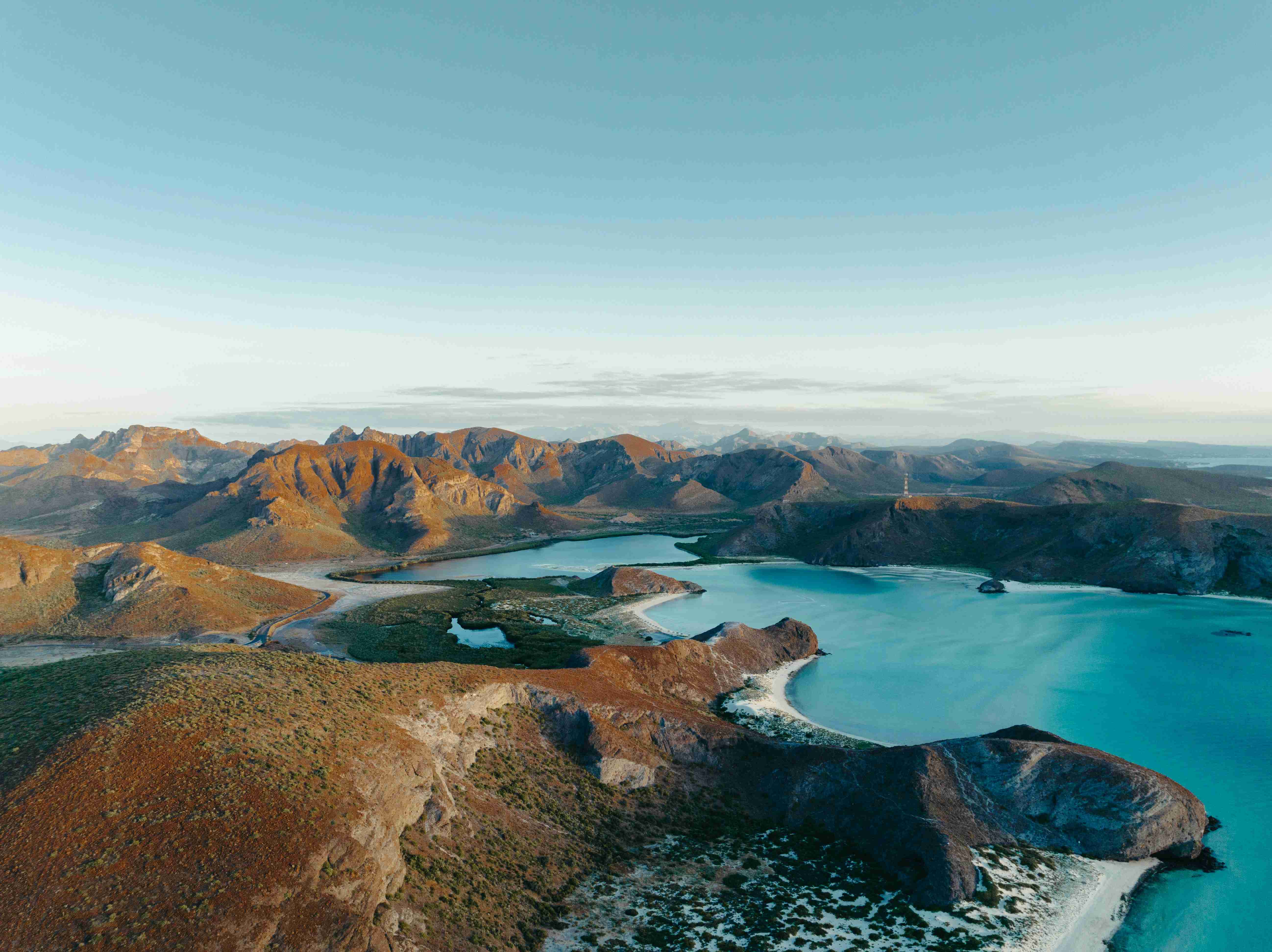 Serene Coastal Lagoon with Mountainous Backdrop at Twilight