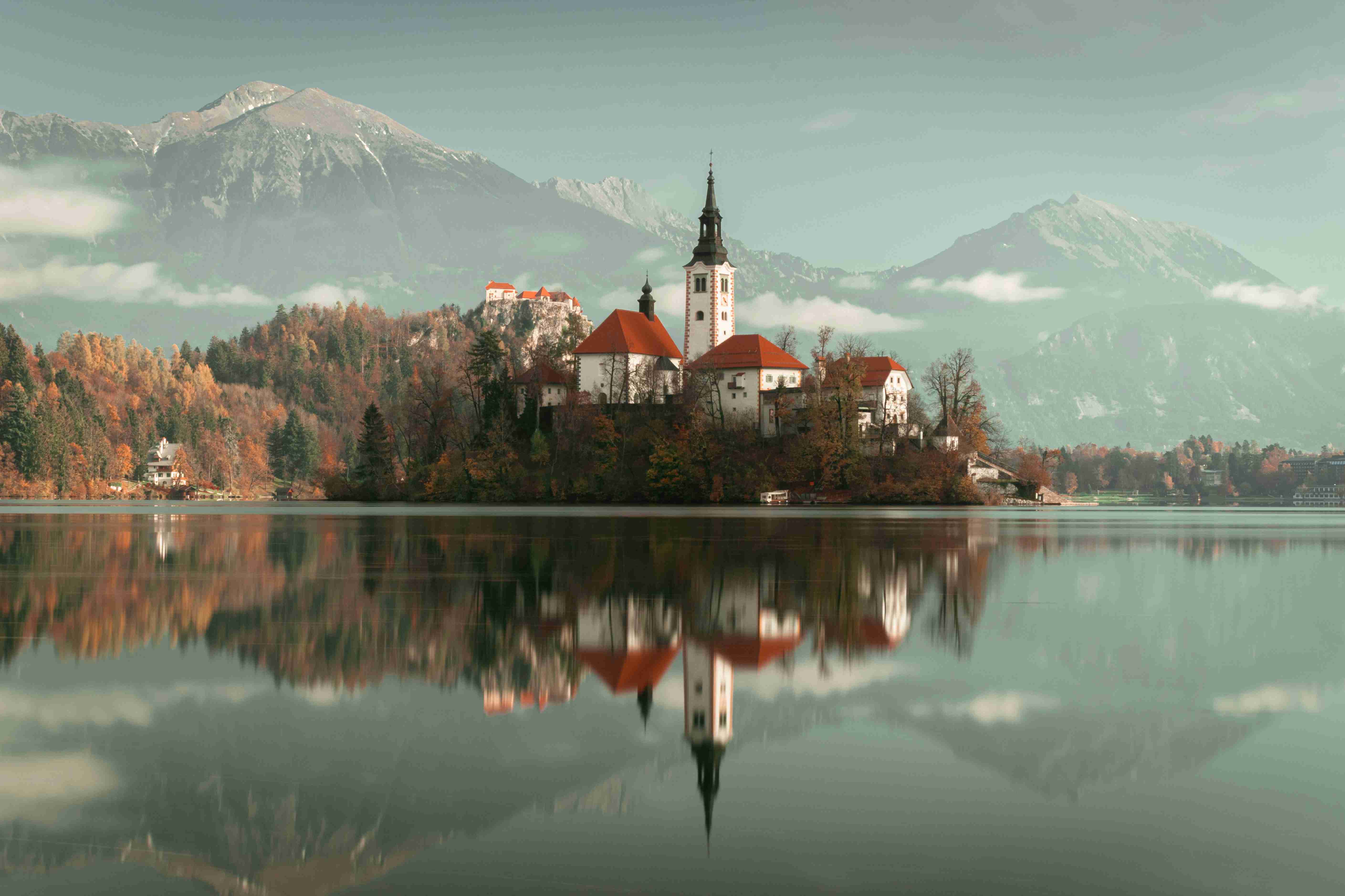 Serene Lake with Castle Island and Misty Mountains in the Background