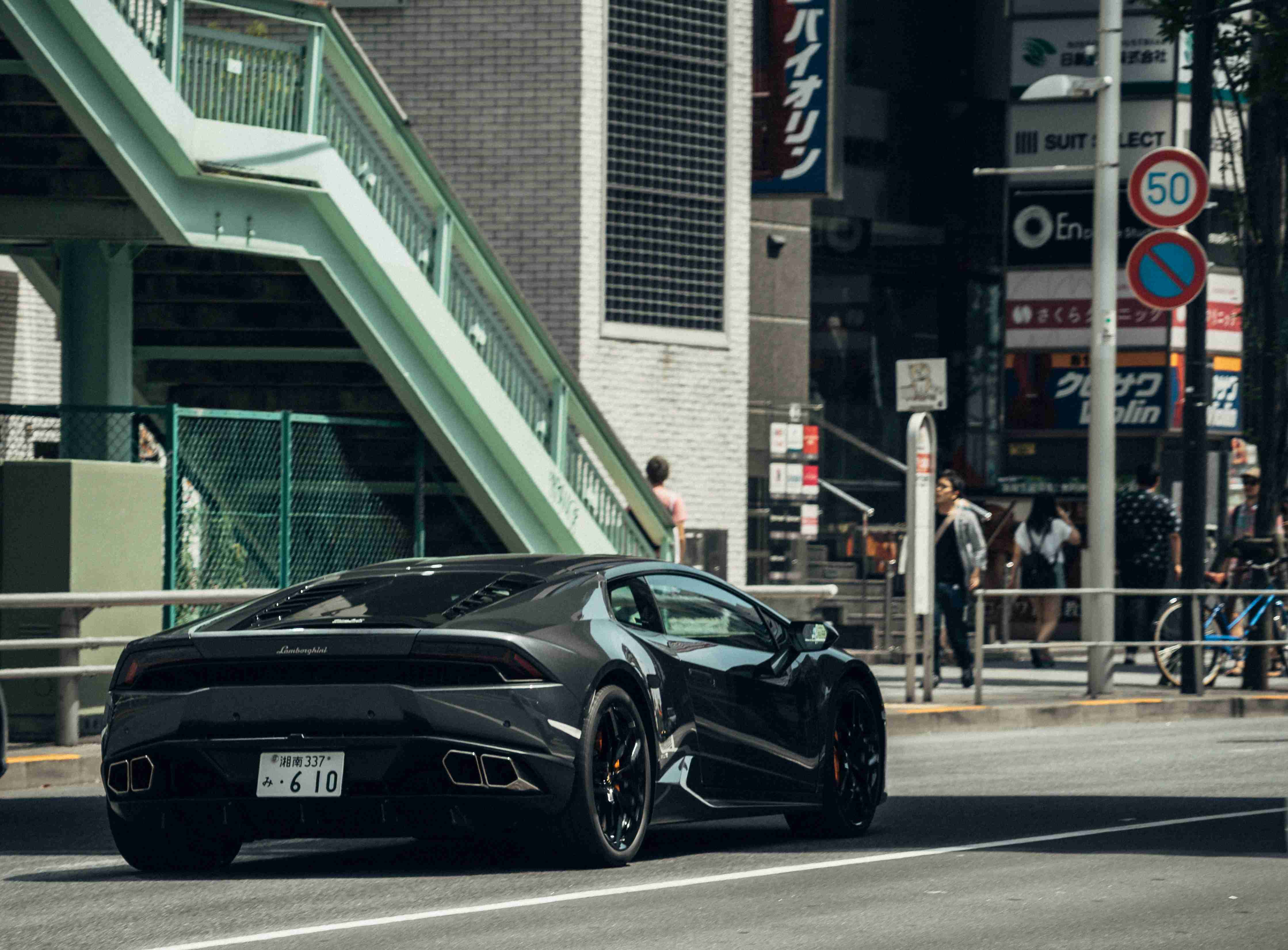 Sleek Black Supercar in Urban Setting