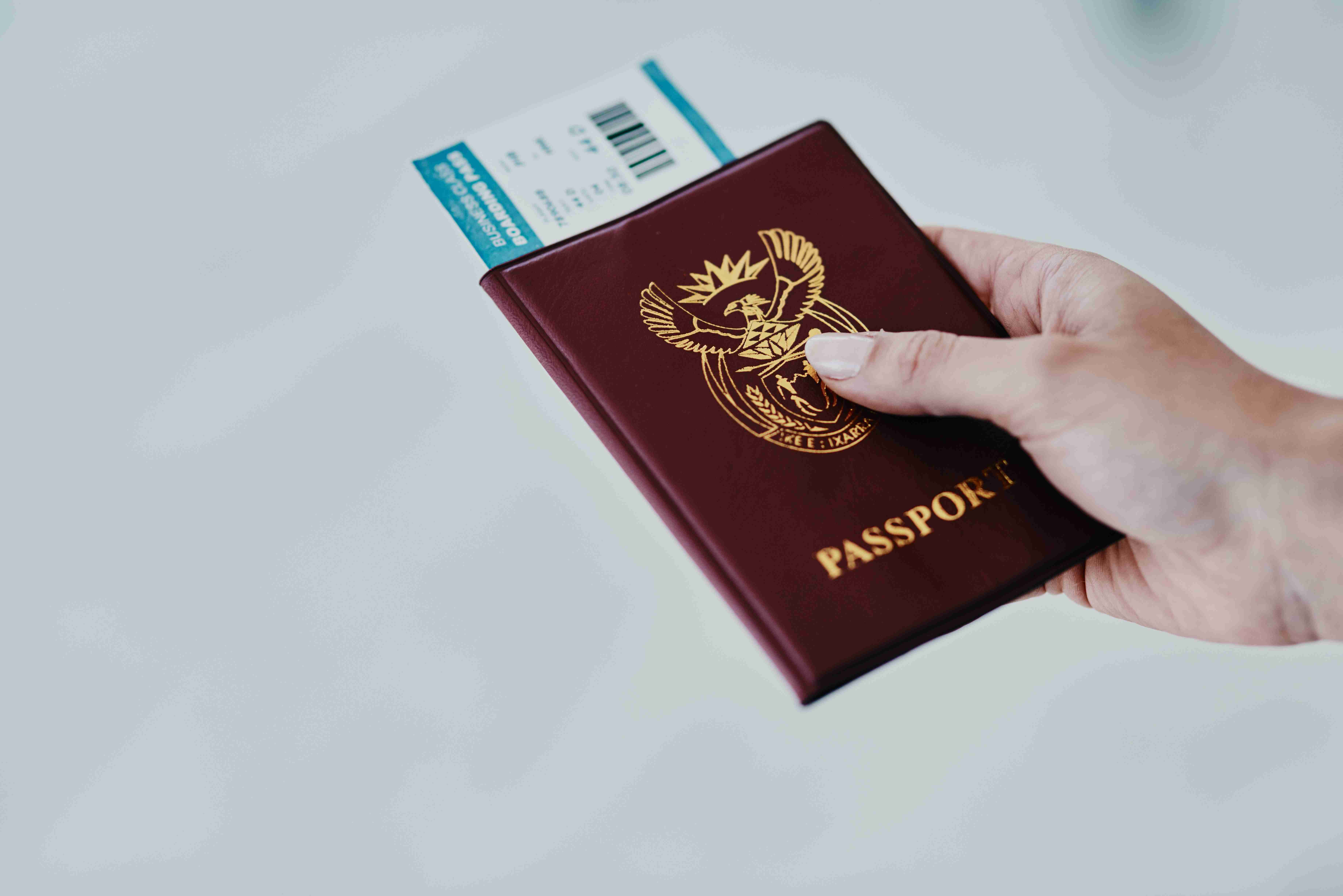 Cropped shot of a woman holding her passport and boarding pass in an airport