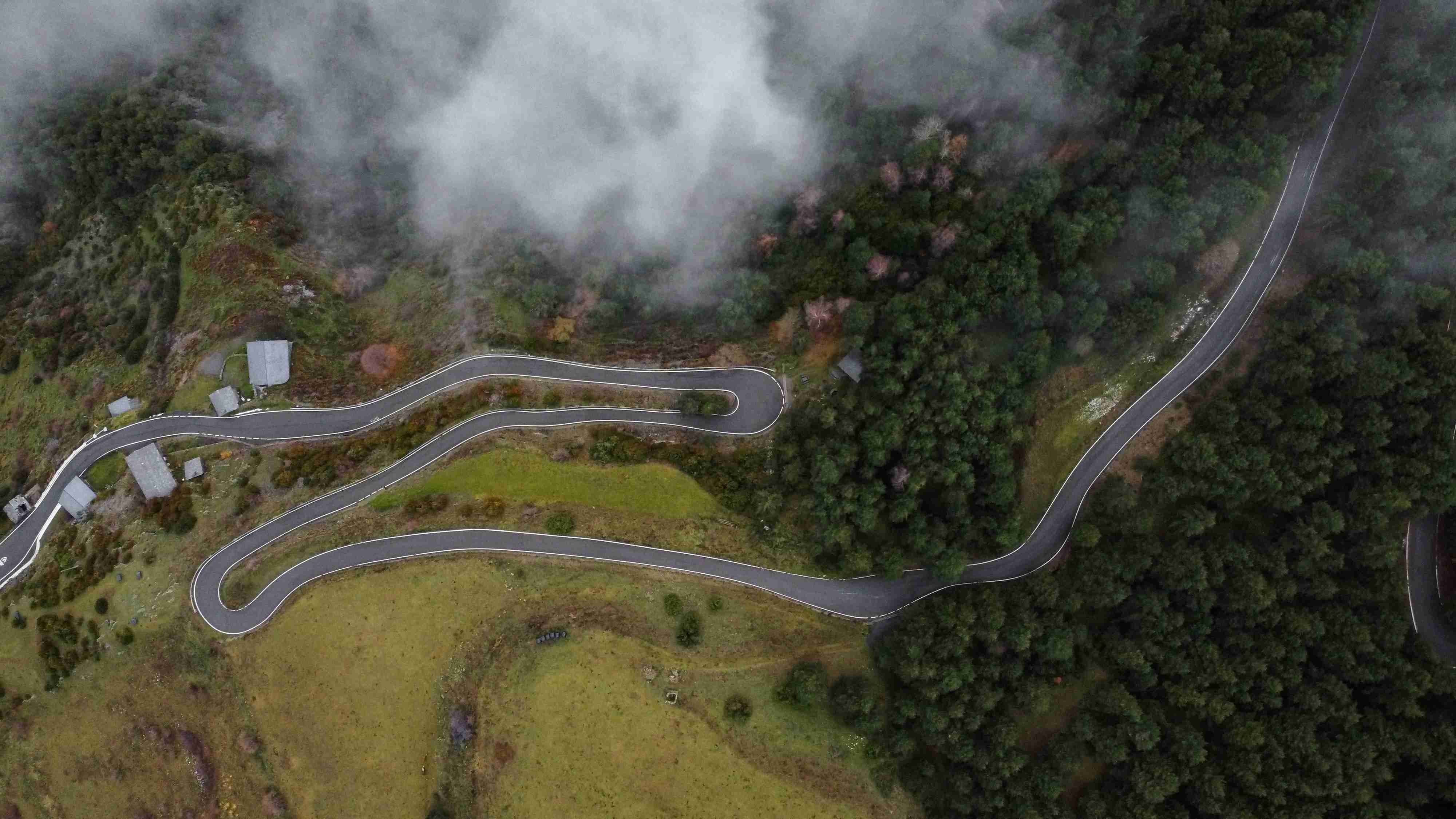 an-aerial-view-of-a-winding-road-in-the-mountains