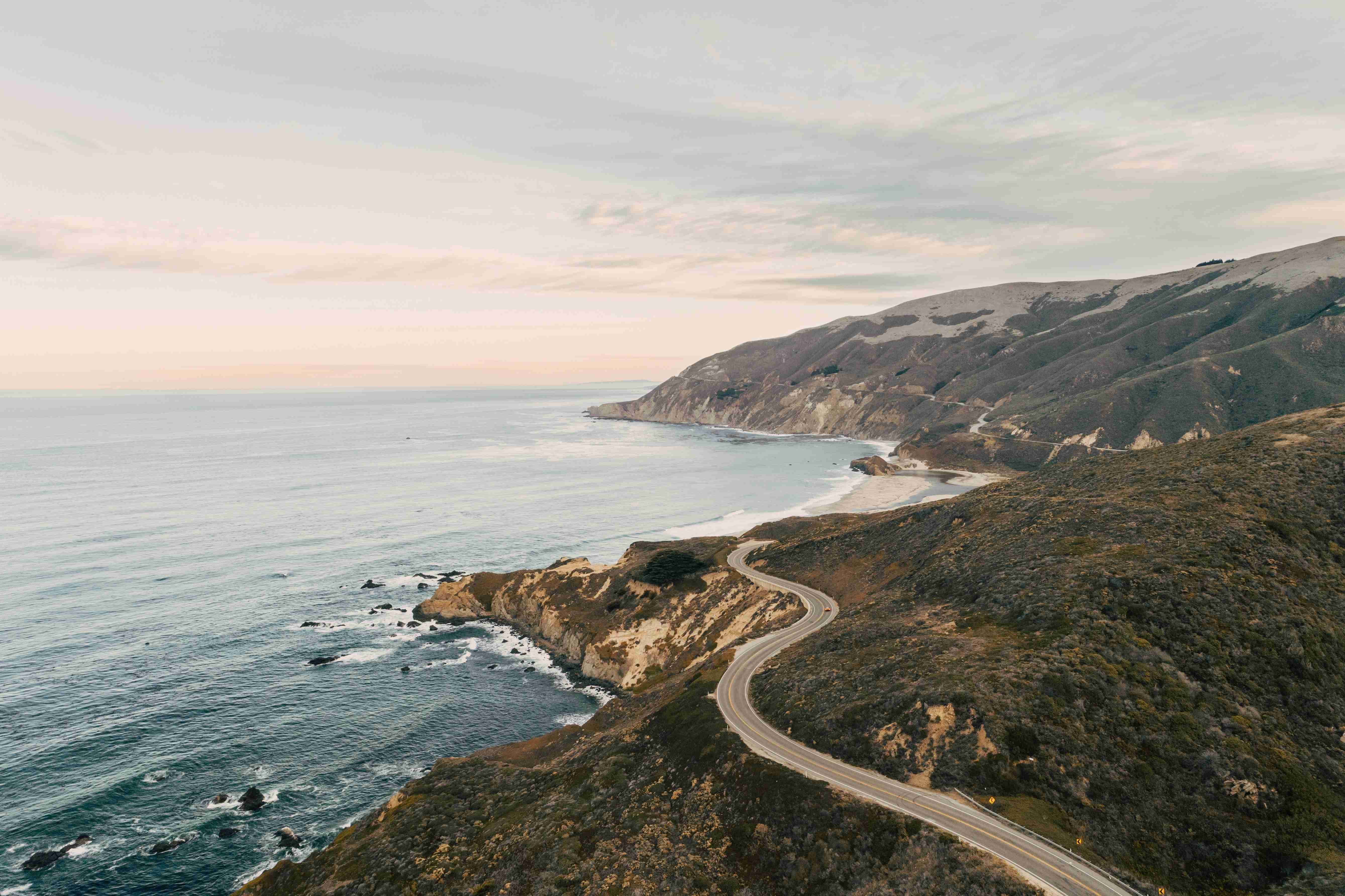 aerial view ocean rock formation covered greenery
