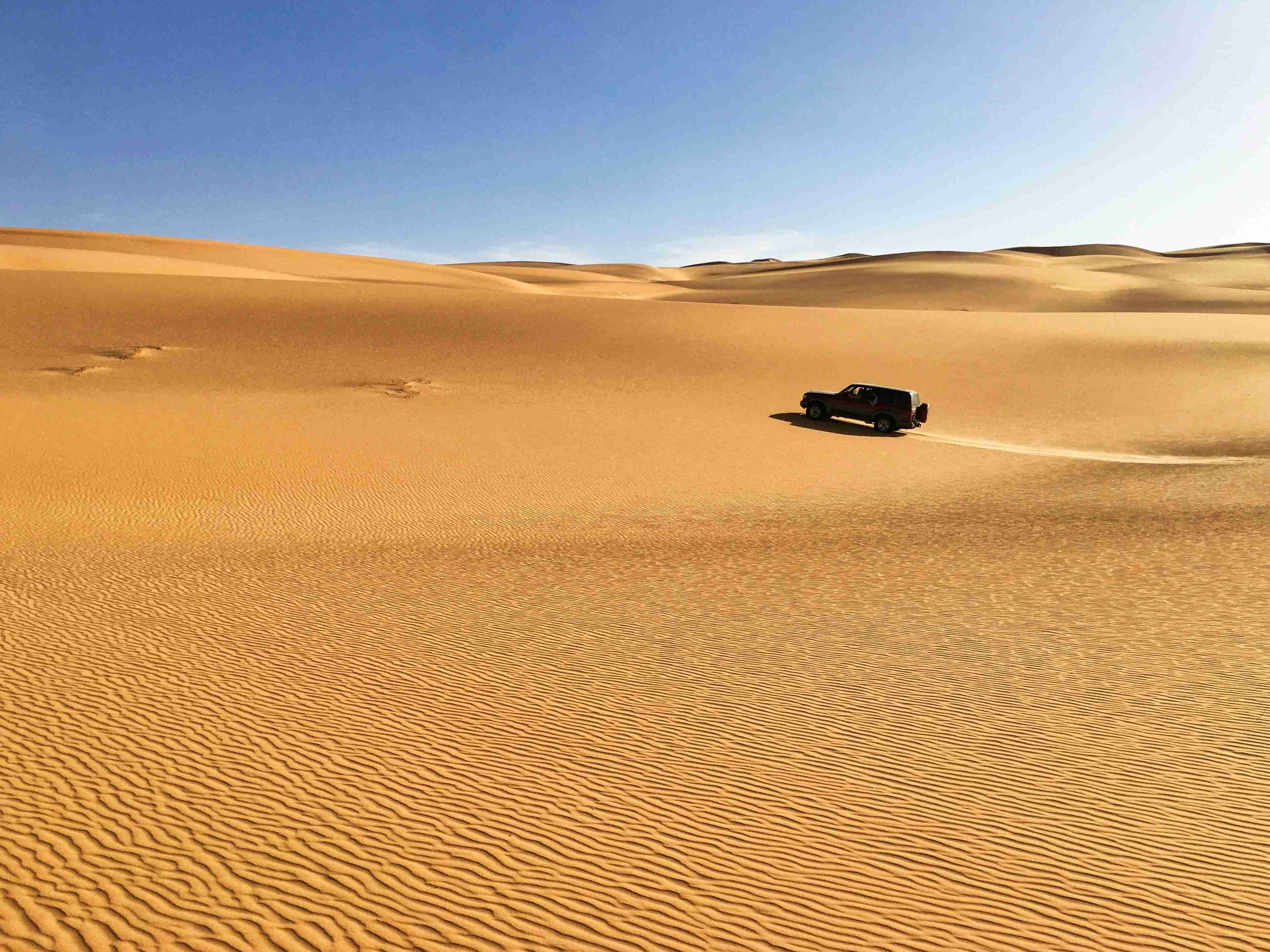 black car on desert during daytime
