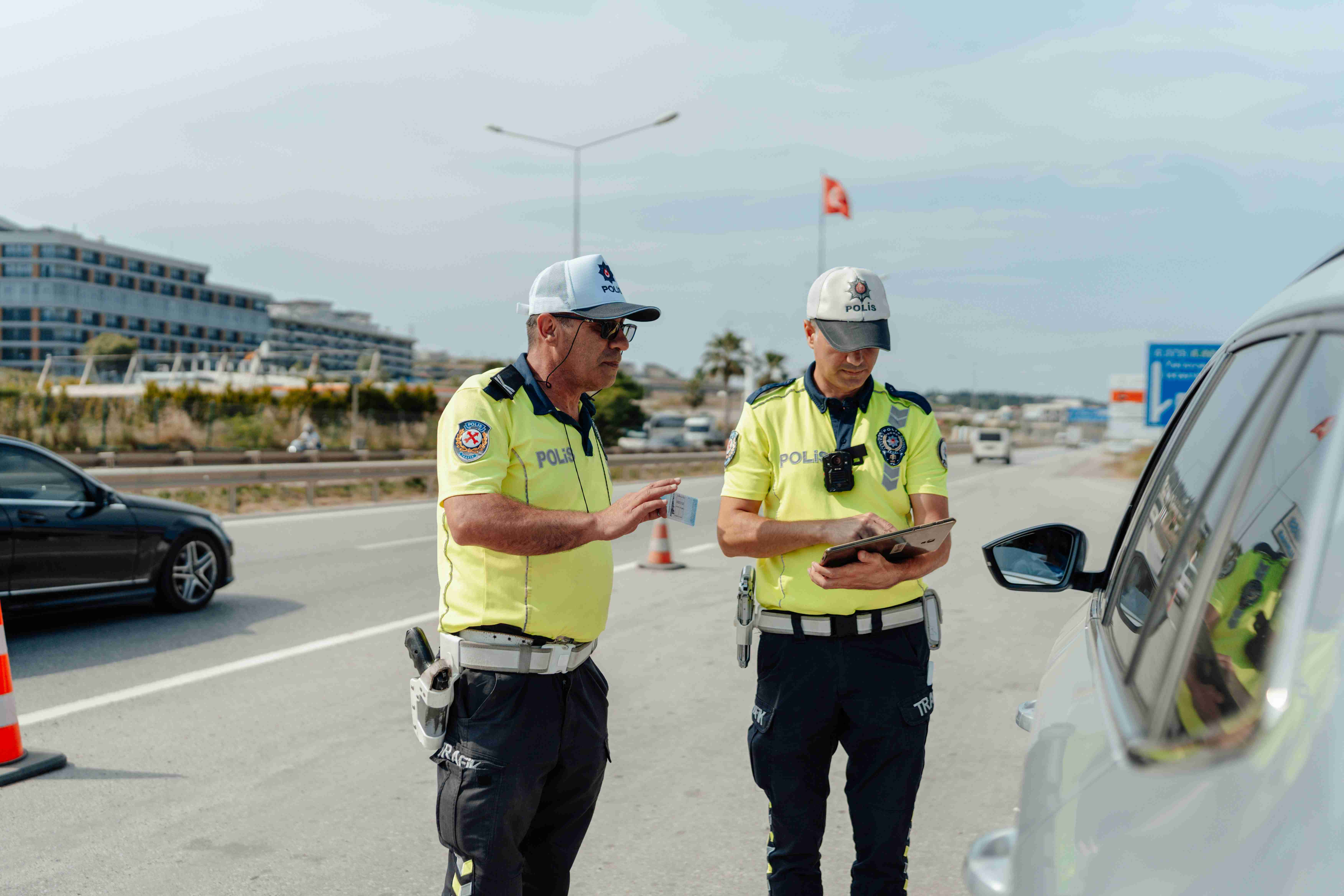 a couple of men standing next to a car