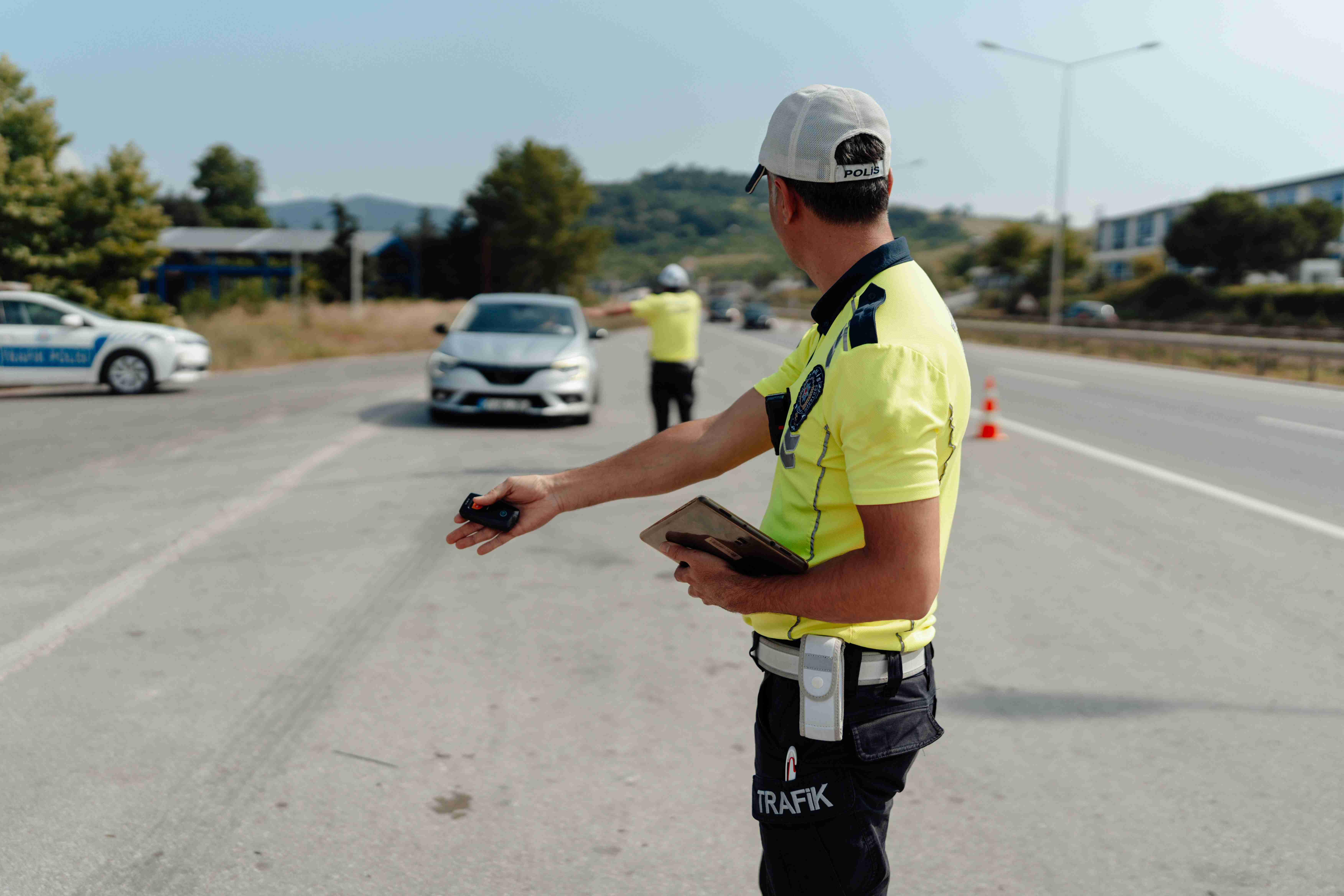 a-police-officer-directing-traffic-on-a-highway