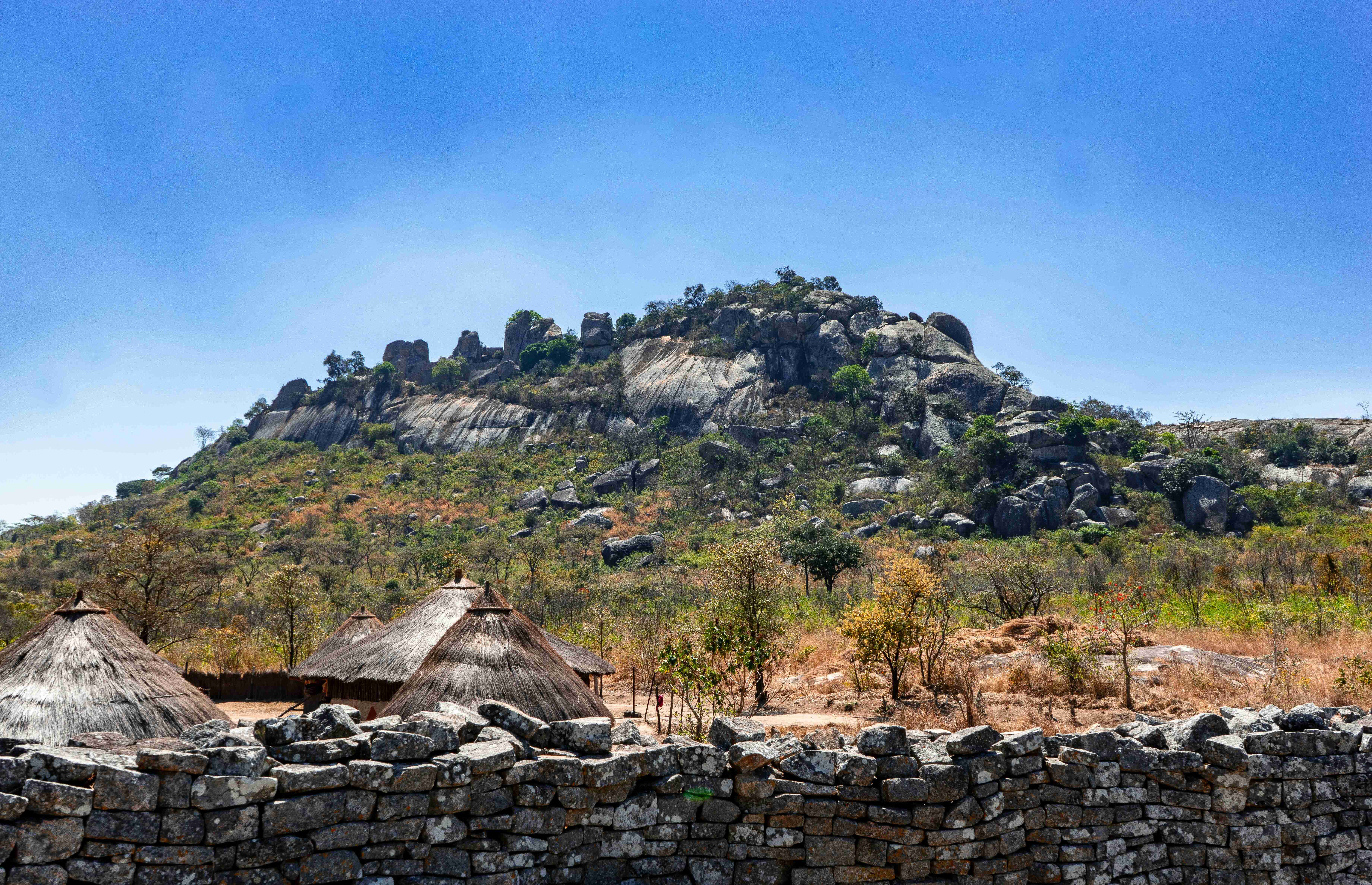 a-rocky-hillside-with-a-stone-wall