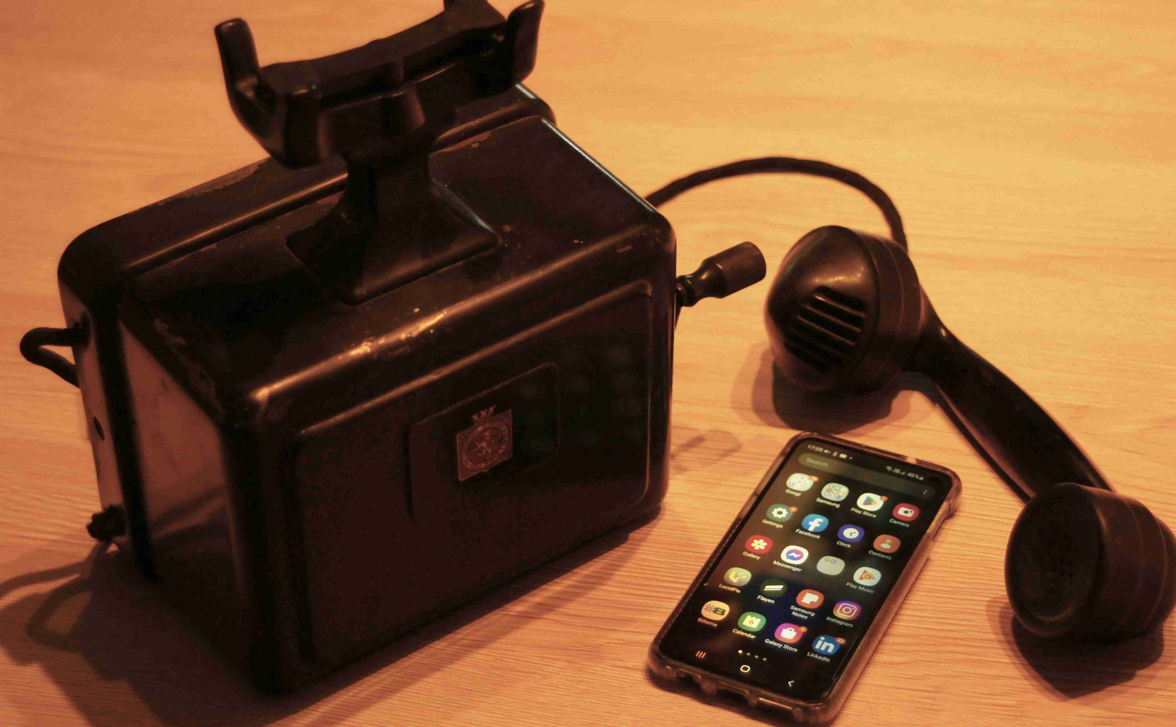 a-black-phone-next-to-a-black-box-with-a-cord