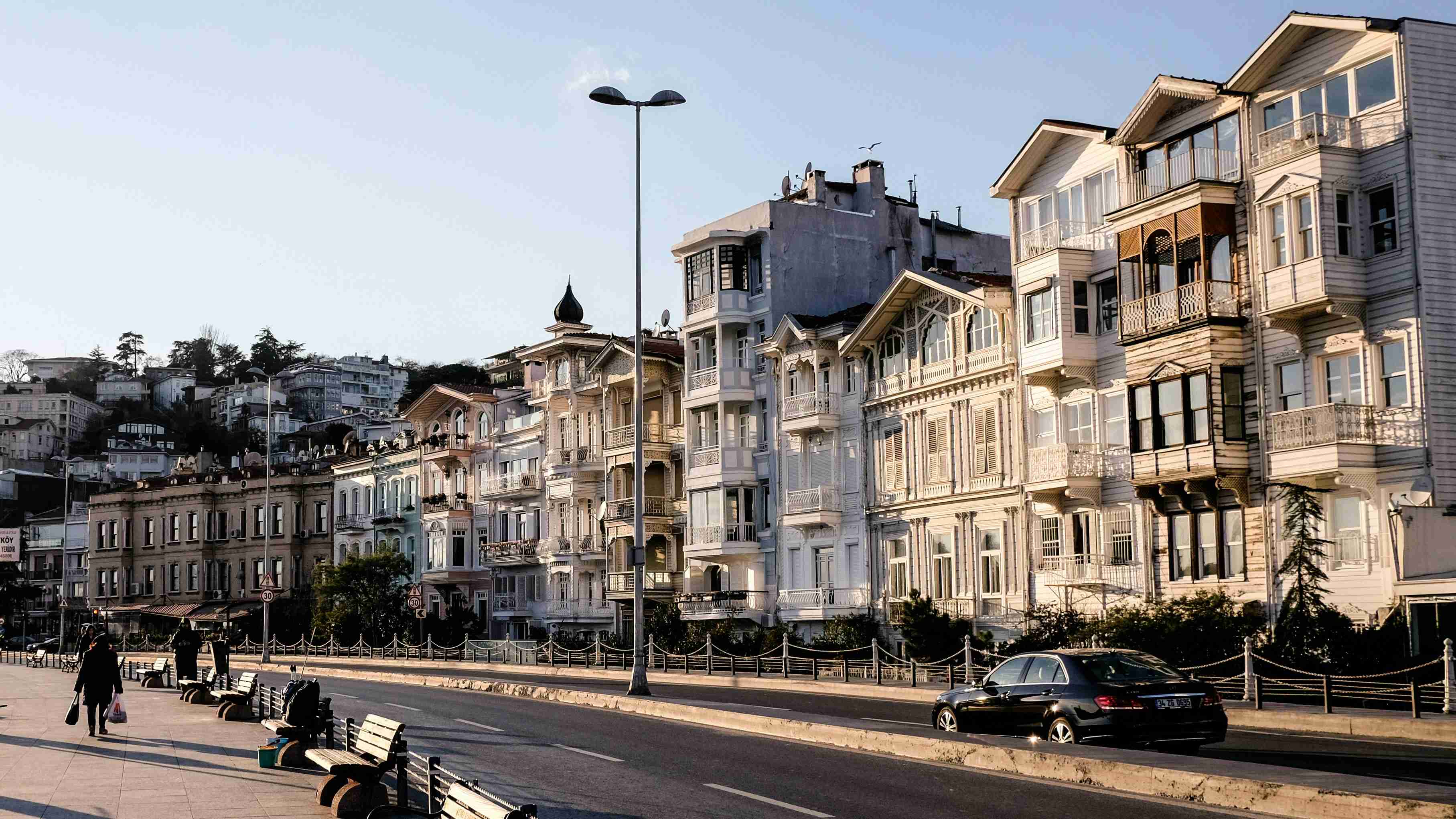 black car parked beside white concrete building