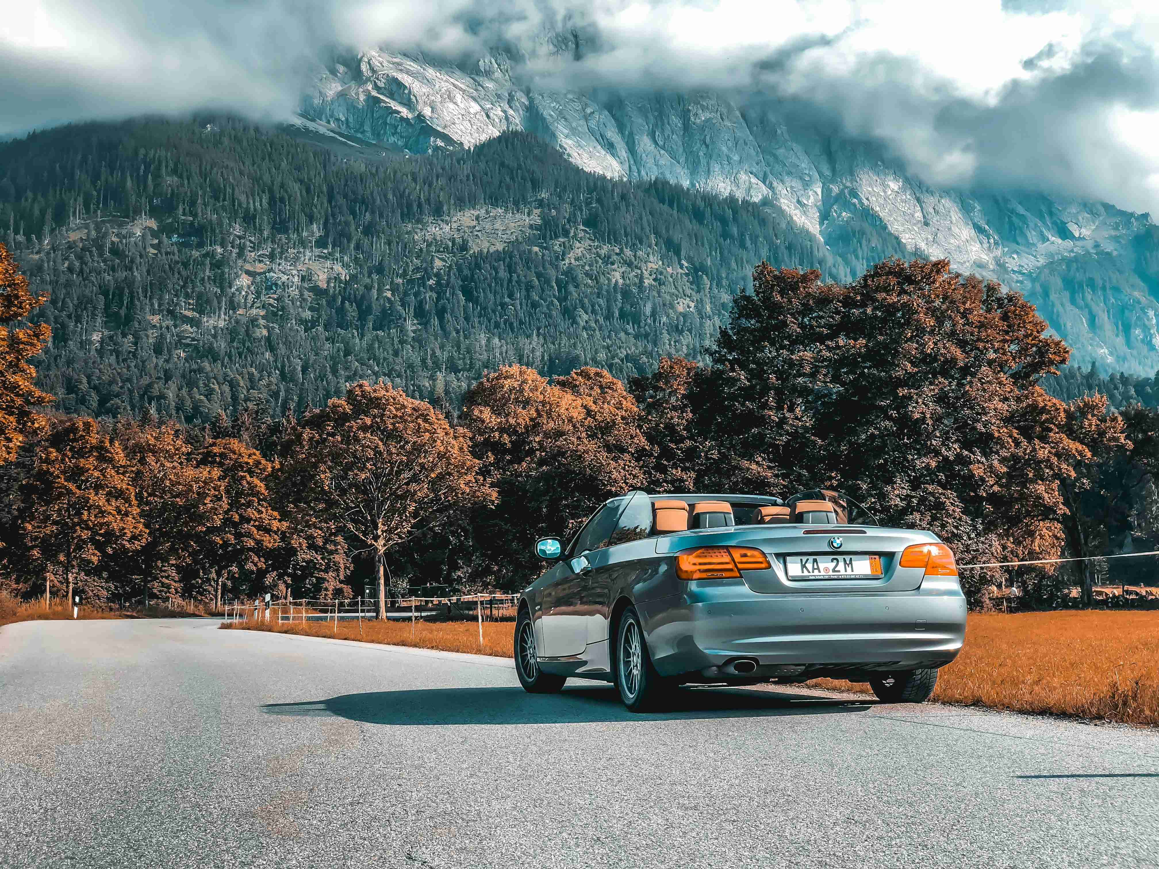 gray convertible coupe on road under white-sky