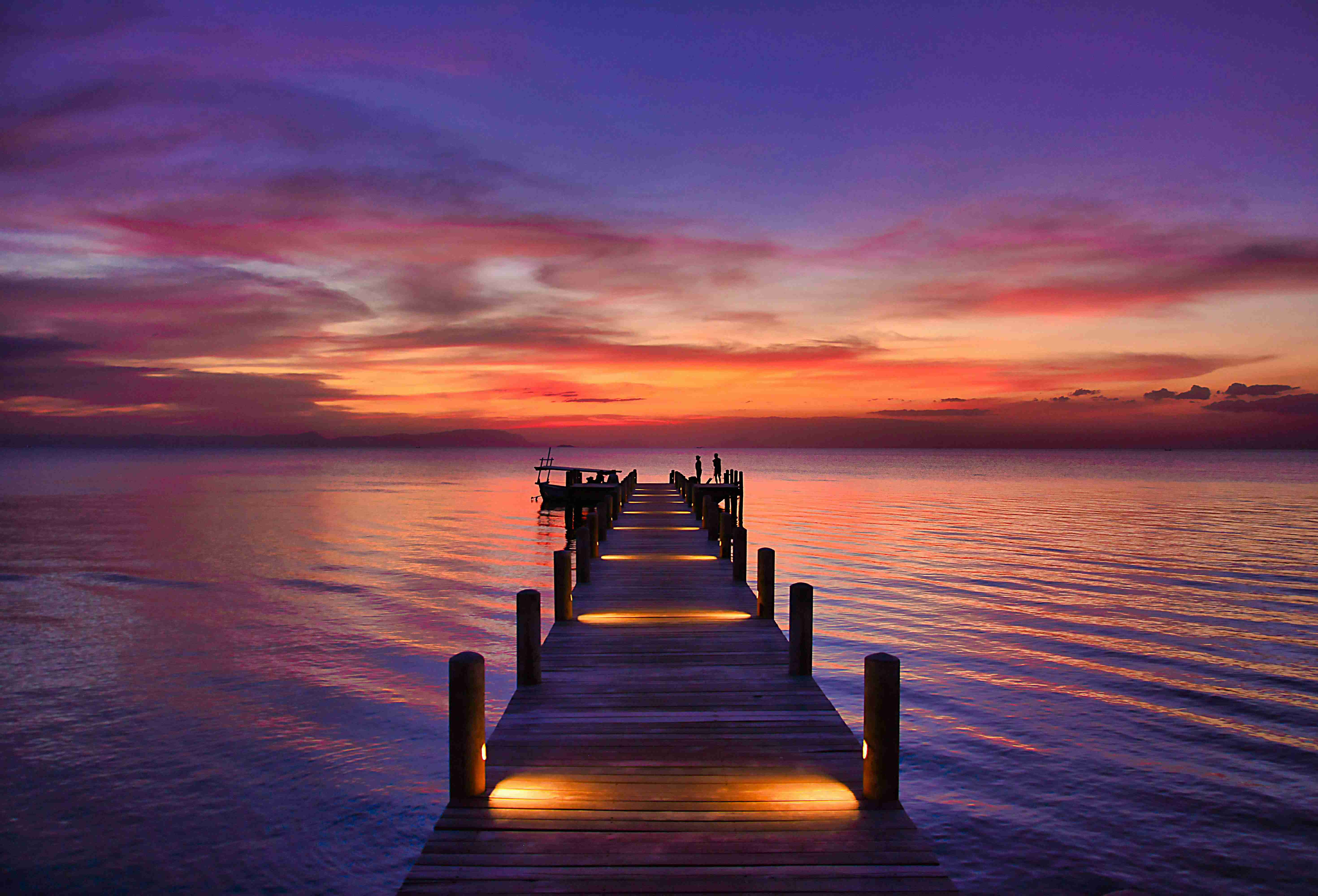 brown-wooden-dock-on-sea-during-sunset