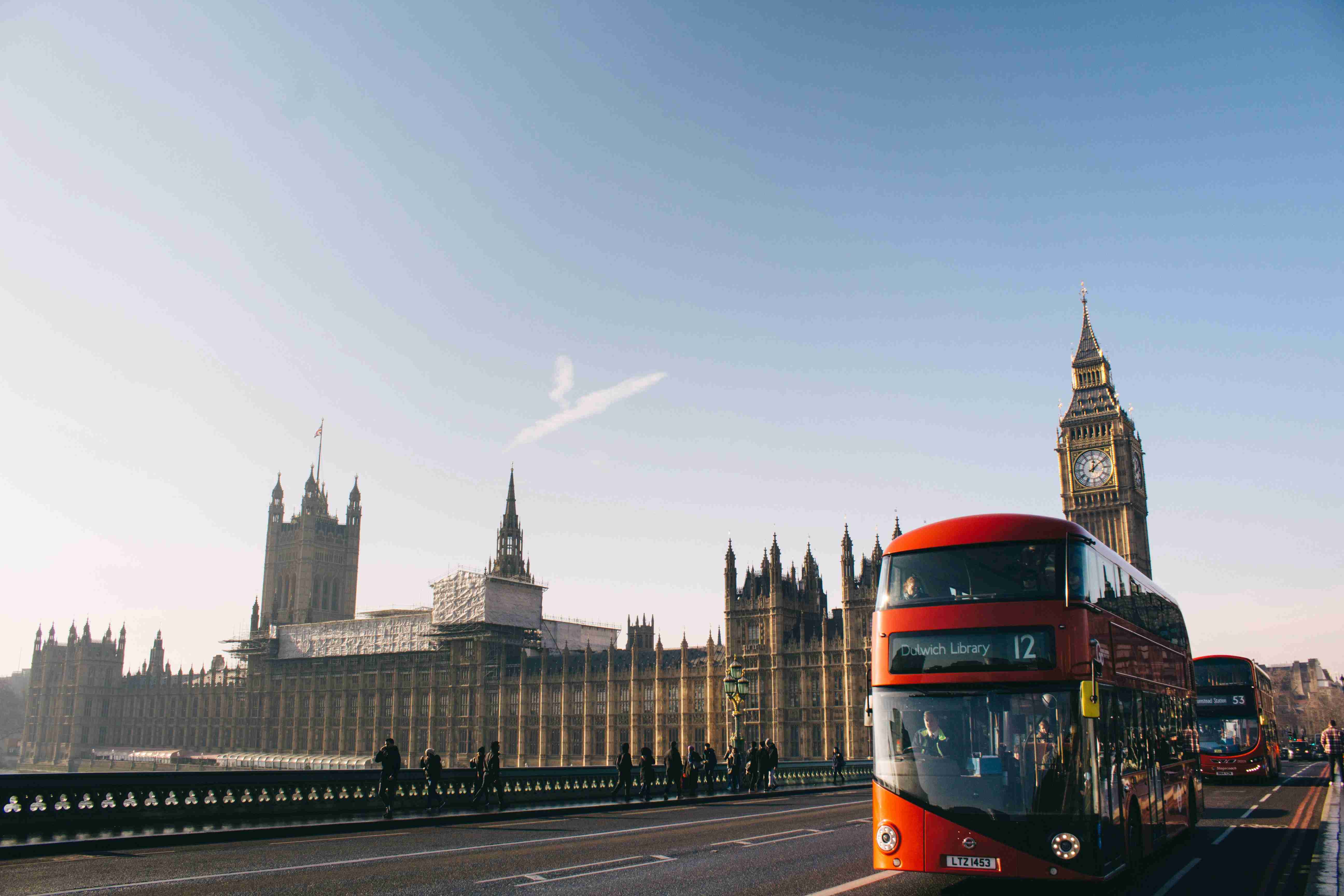 red-double-decker-bus-passing-palace-of-westminster-london
