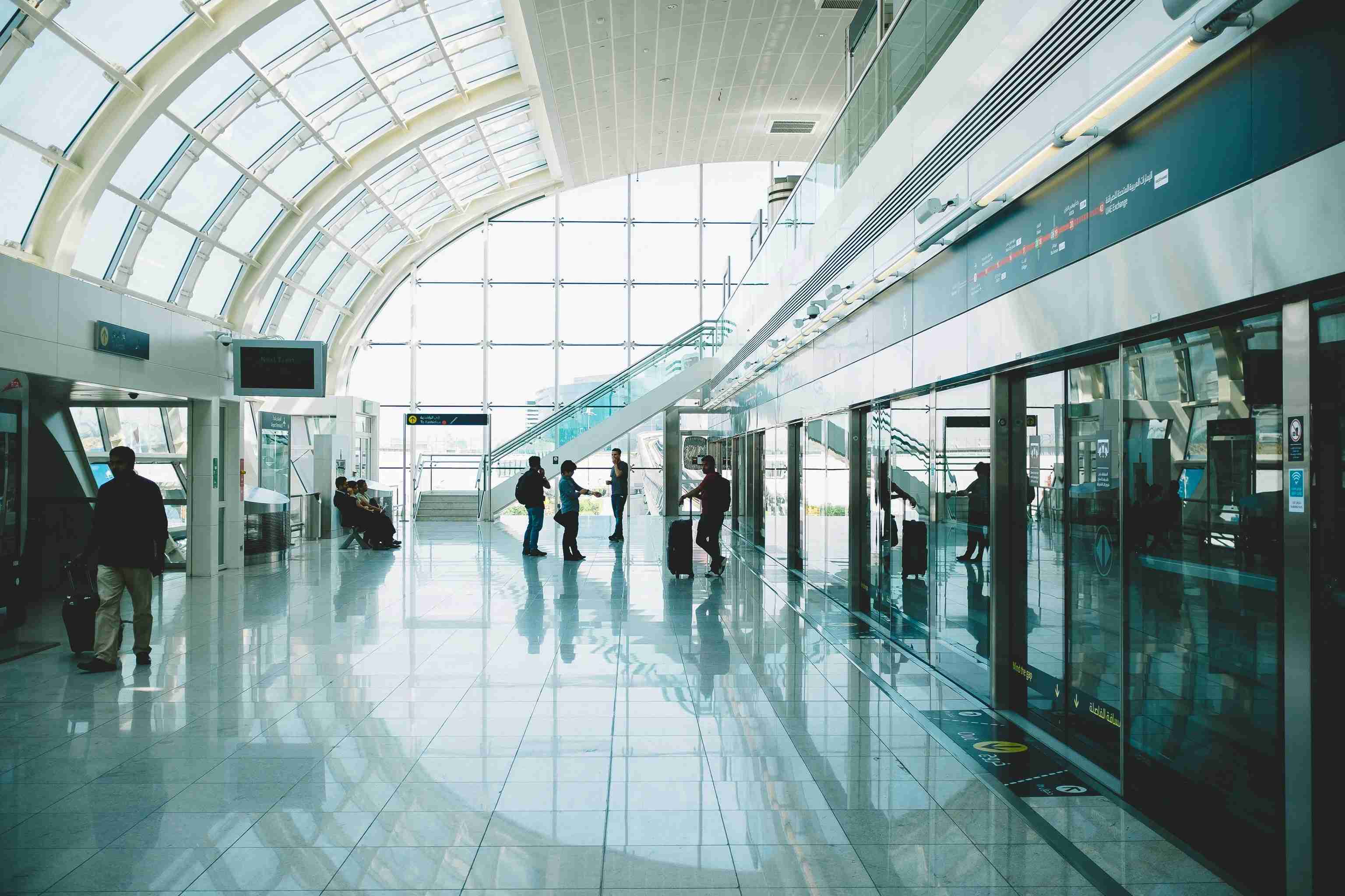 people on a glossy floor in an airport in dubai