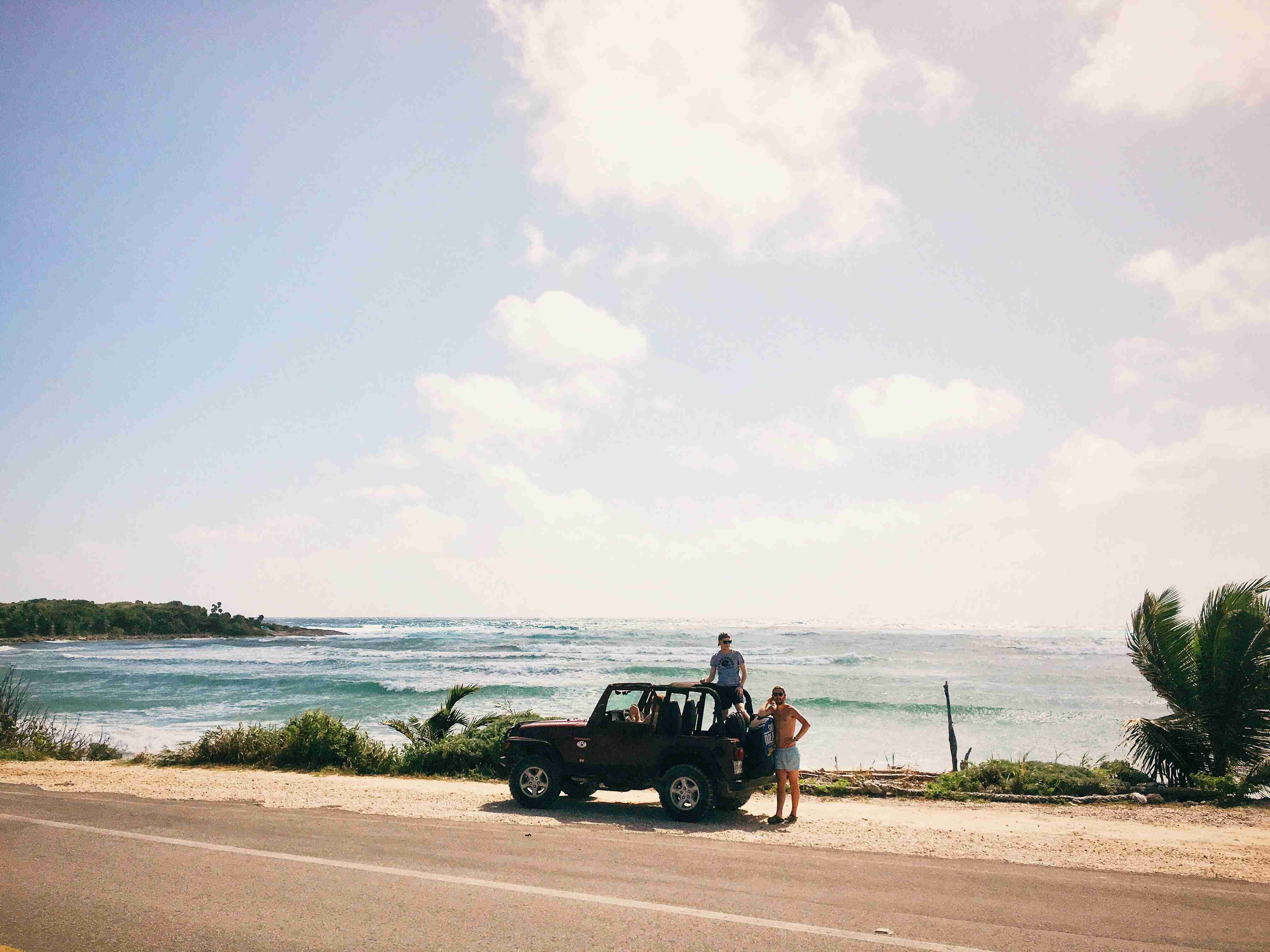 two men on brown suv at daytime