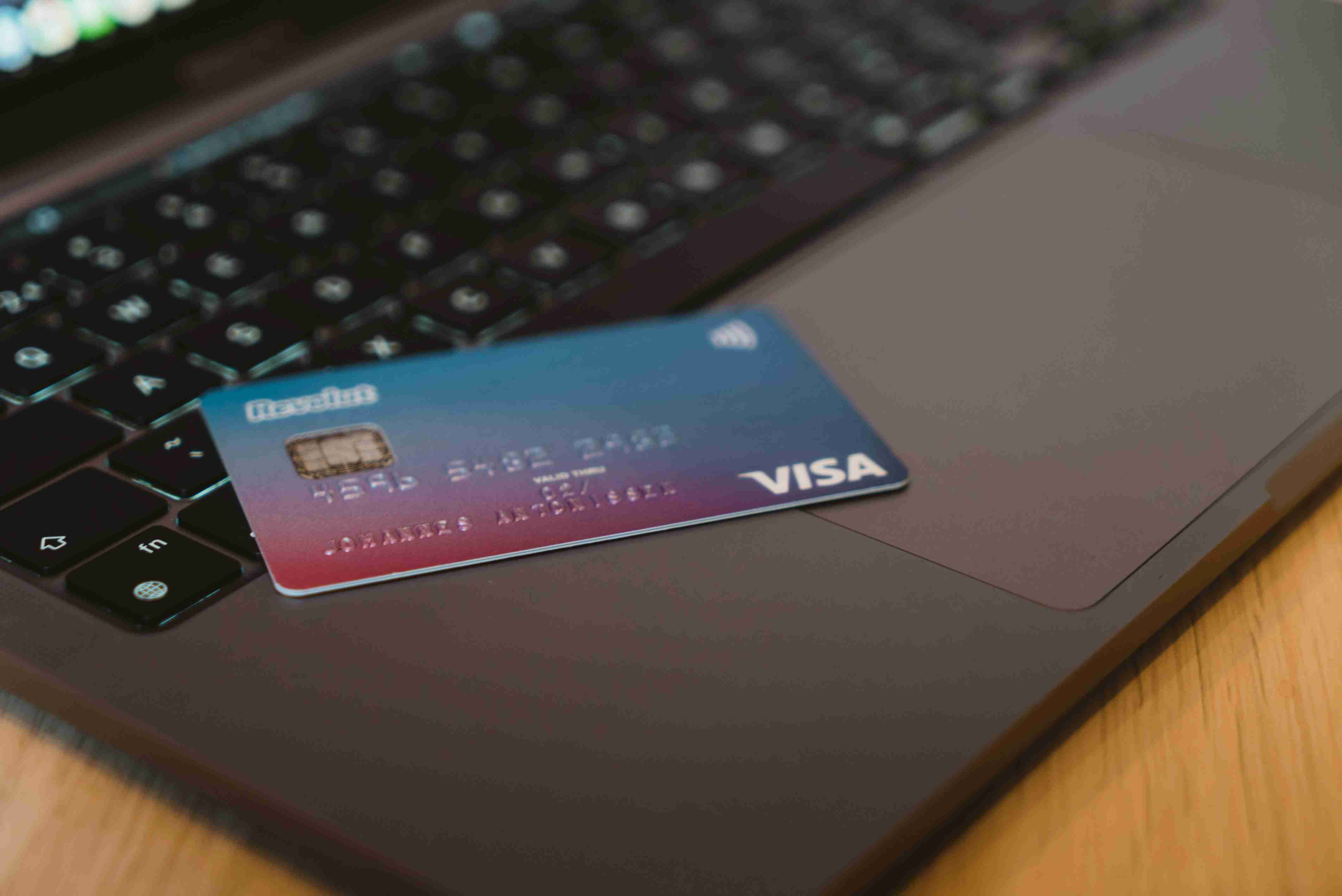 carta visa blu e bianca su computer portatile argento