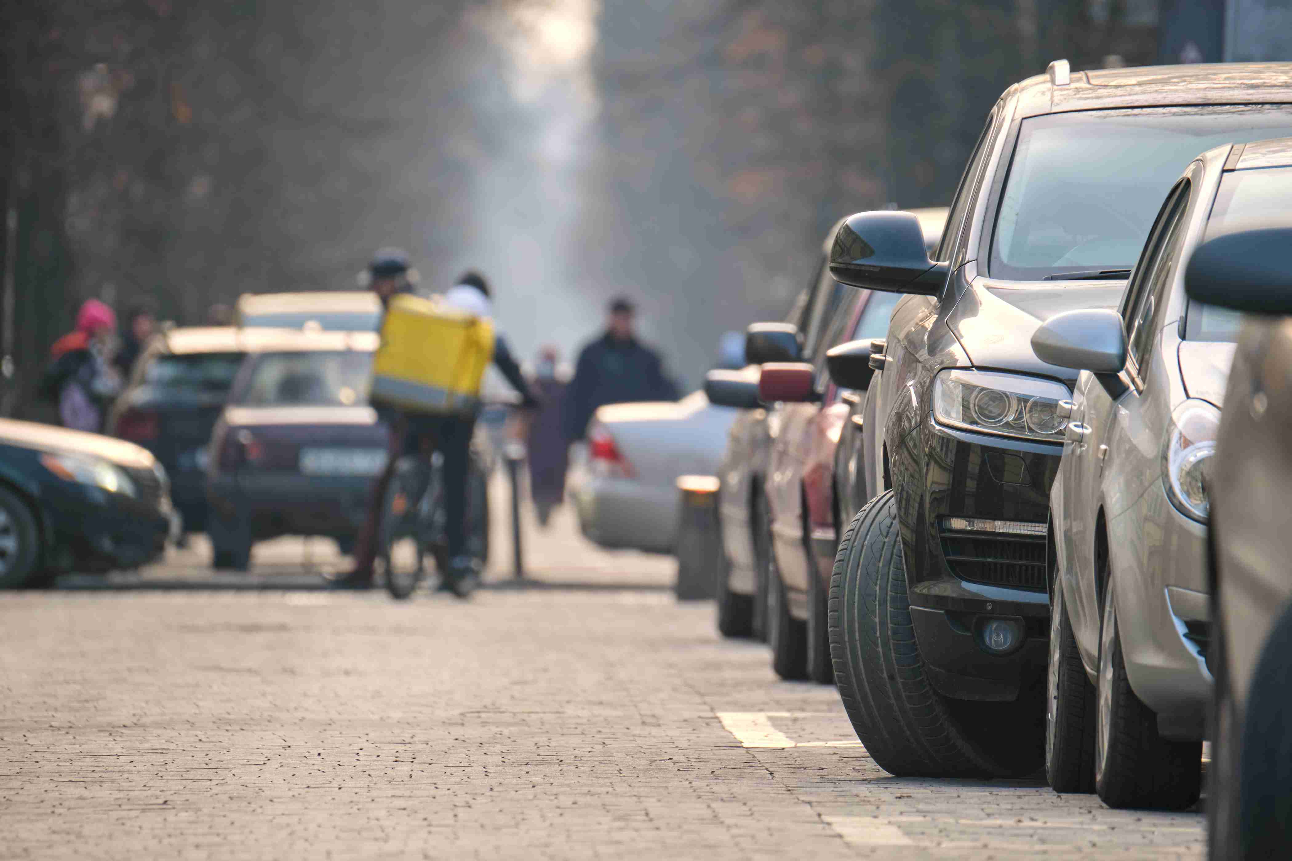 City traffic with cars parked in line on street side