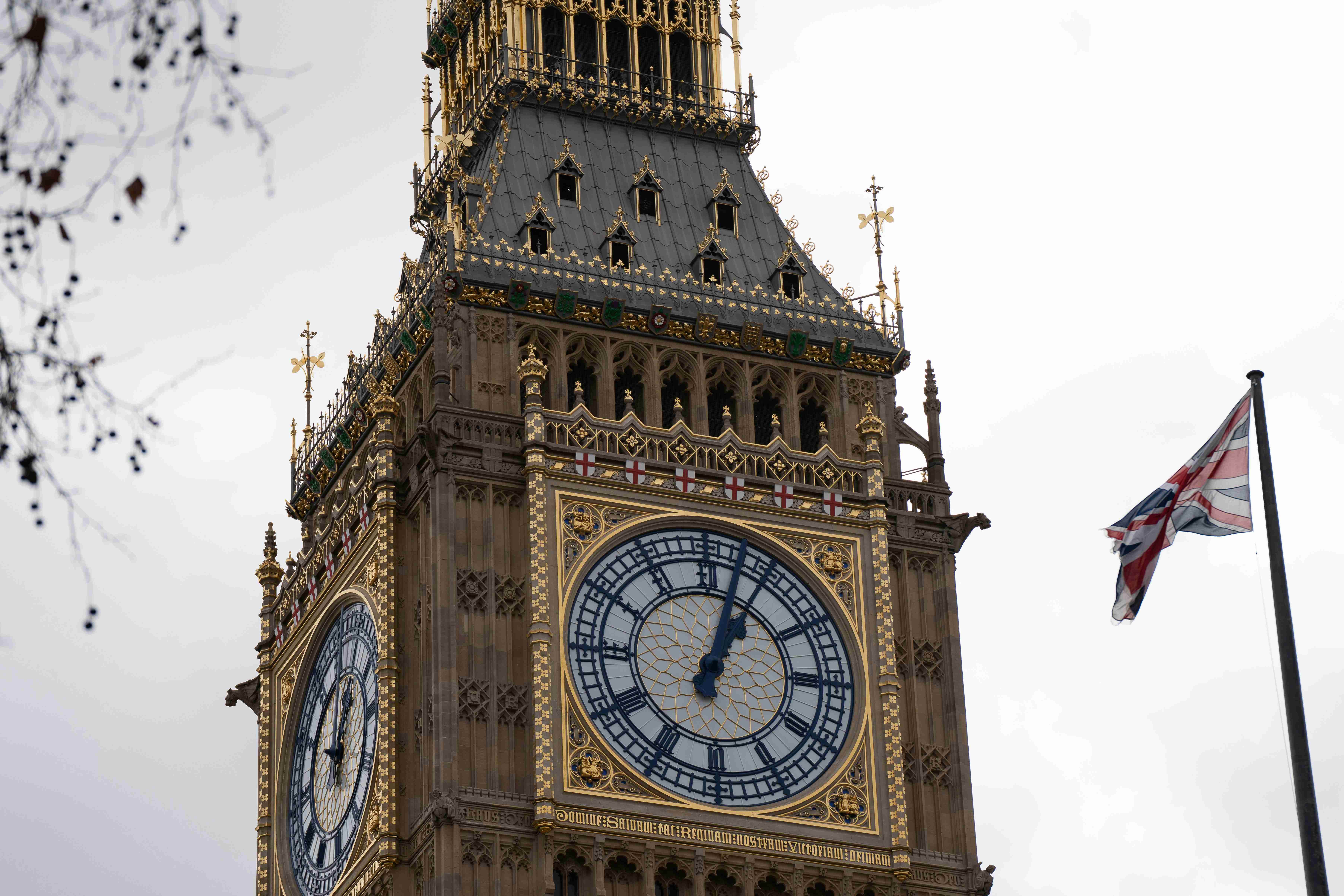 a-clock-tower-with-a-british-flag-flying-in-the-background