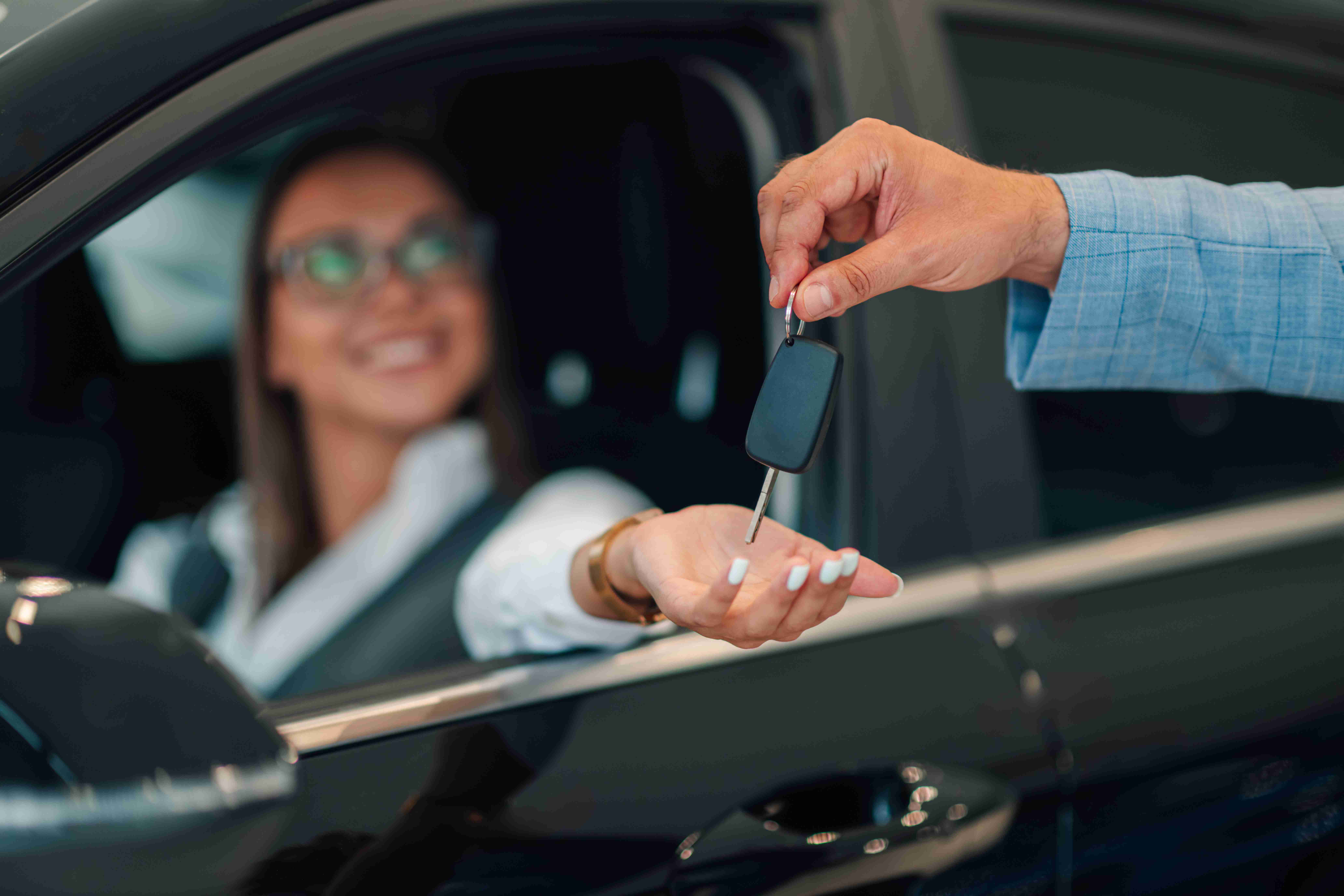 Close-up of woman smiling, receiving car keys