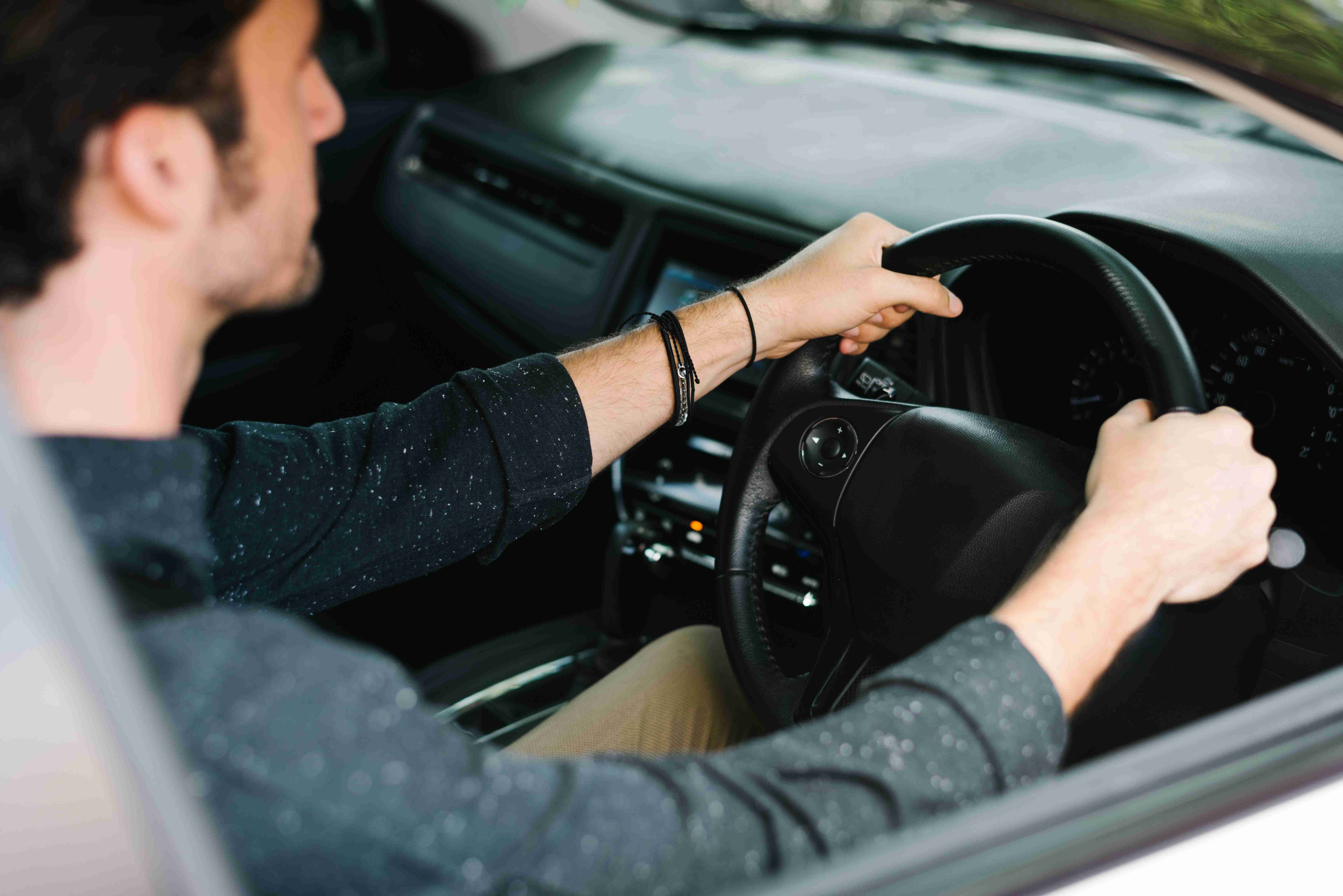 male driver sitting in a car