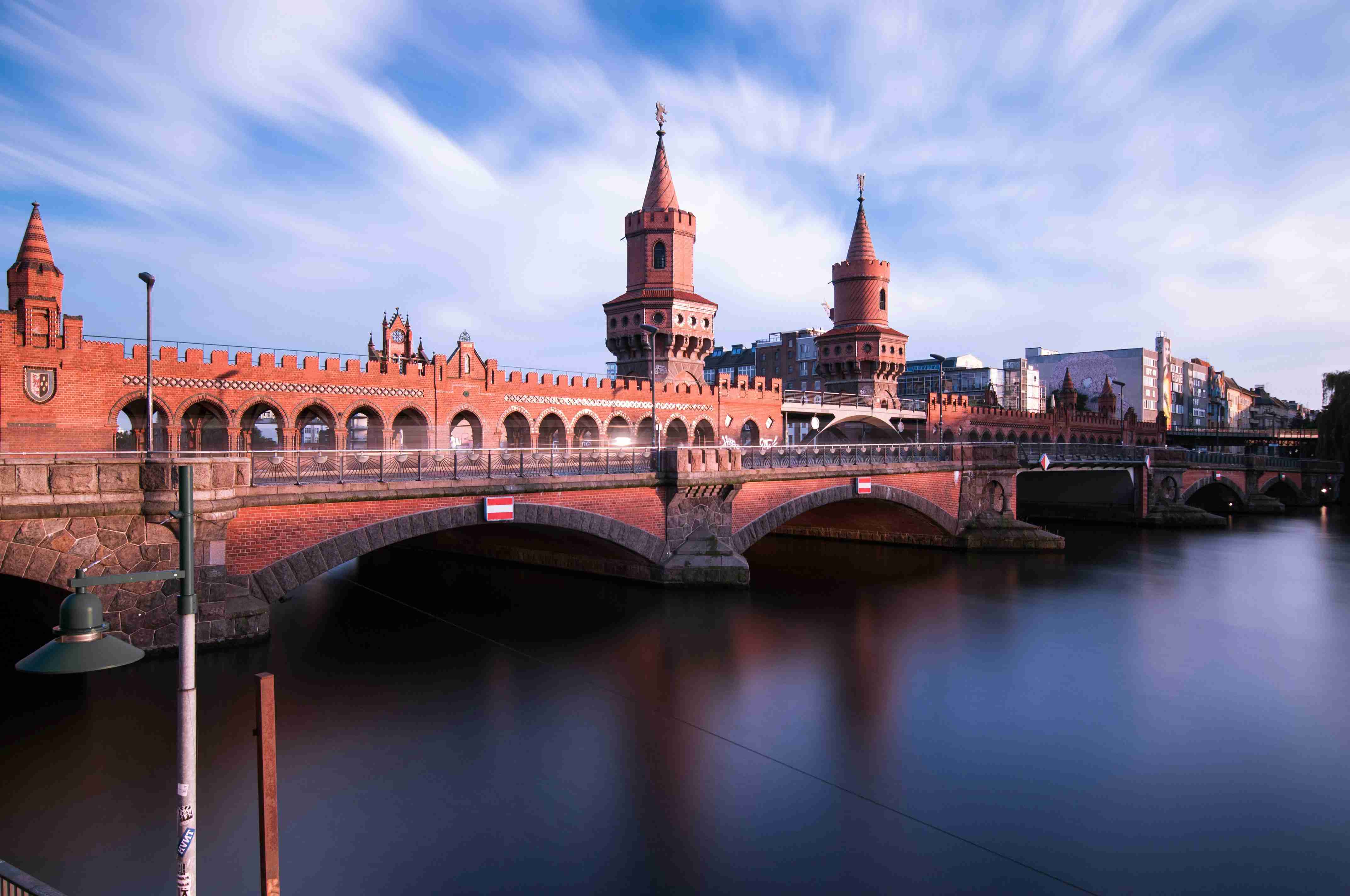 a-bridge-over-a-body-of-water-with-buildings-in-the-background