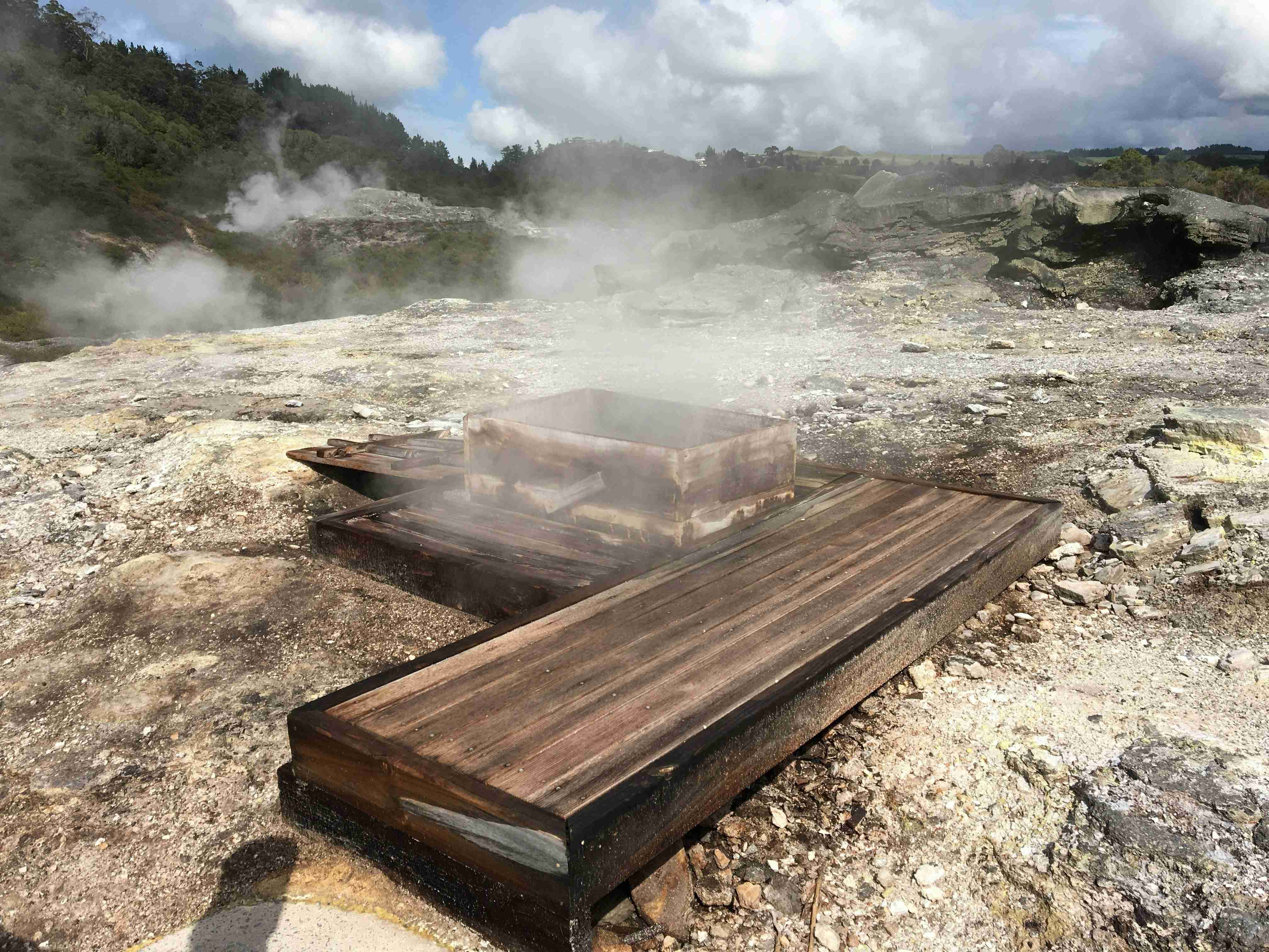 a-wooden-bench-sitting-on-top-of-a-rocky-hillside