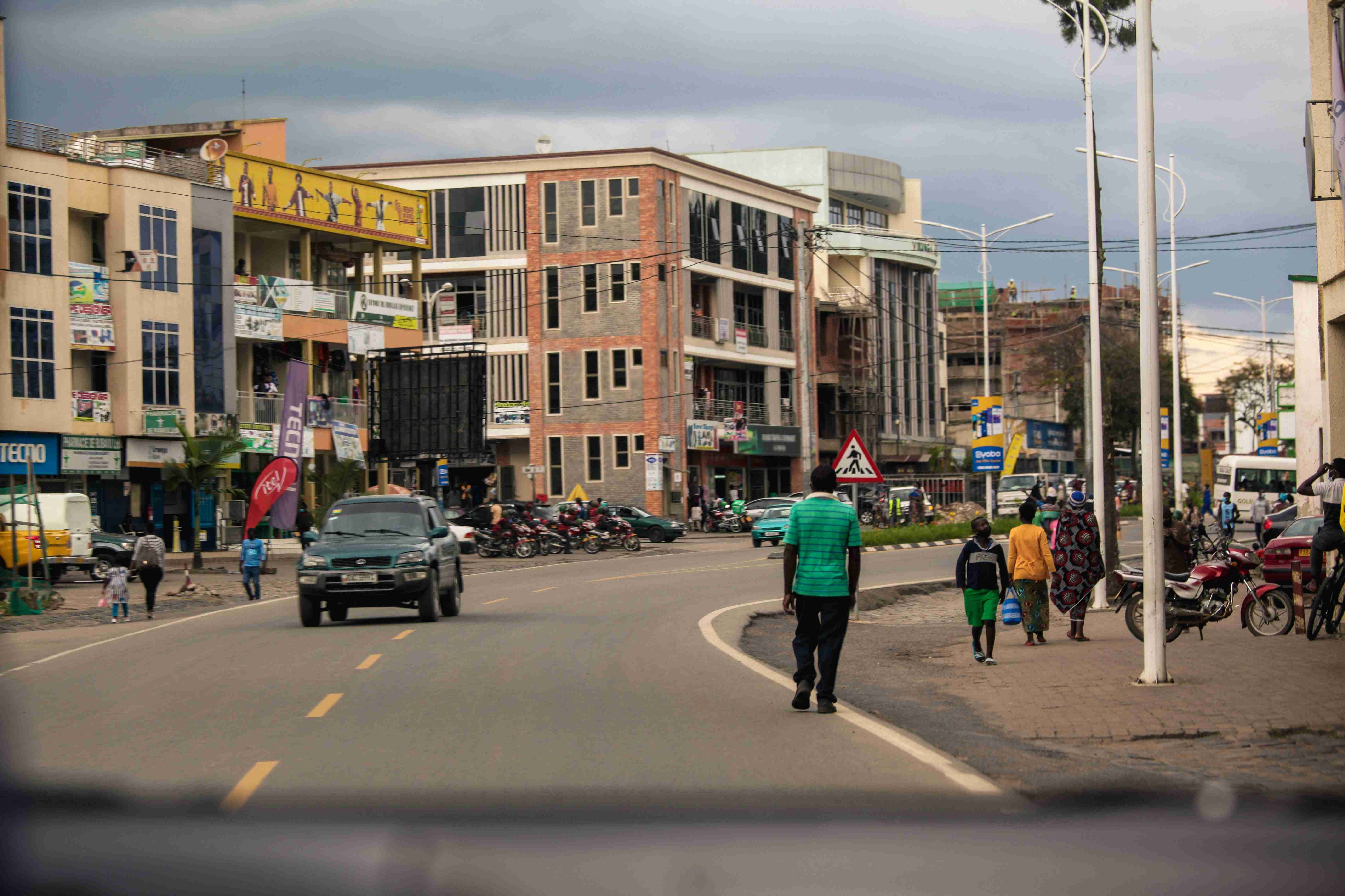 a-group-of-people-walking-down-a-street