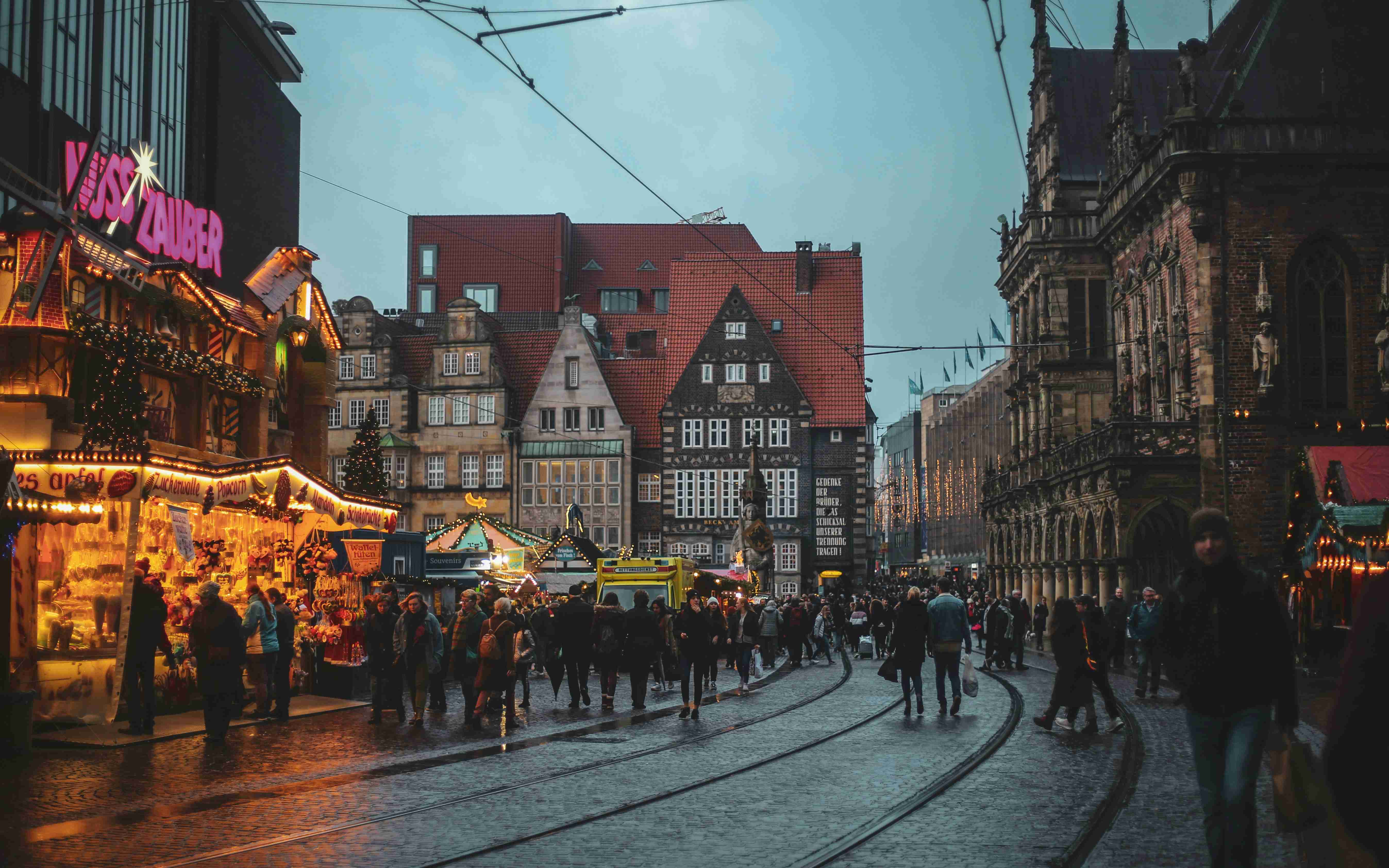 a crowd of people walking down a street