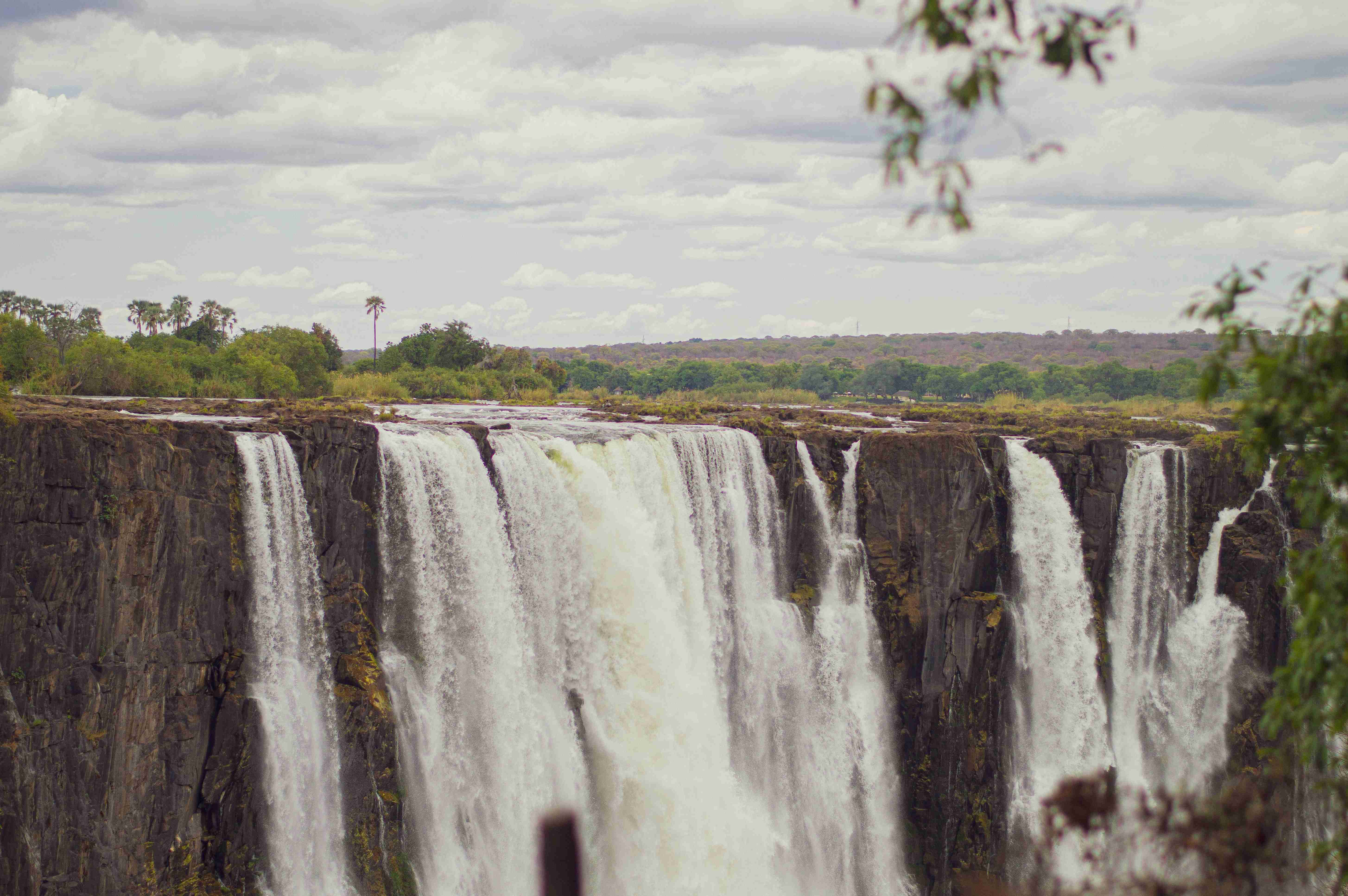 a-large-waterfall-with-trees-in-the-background