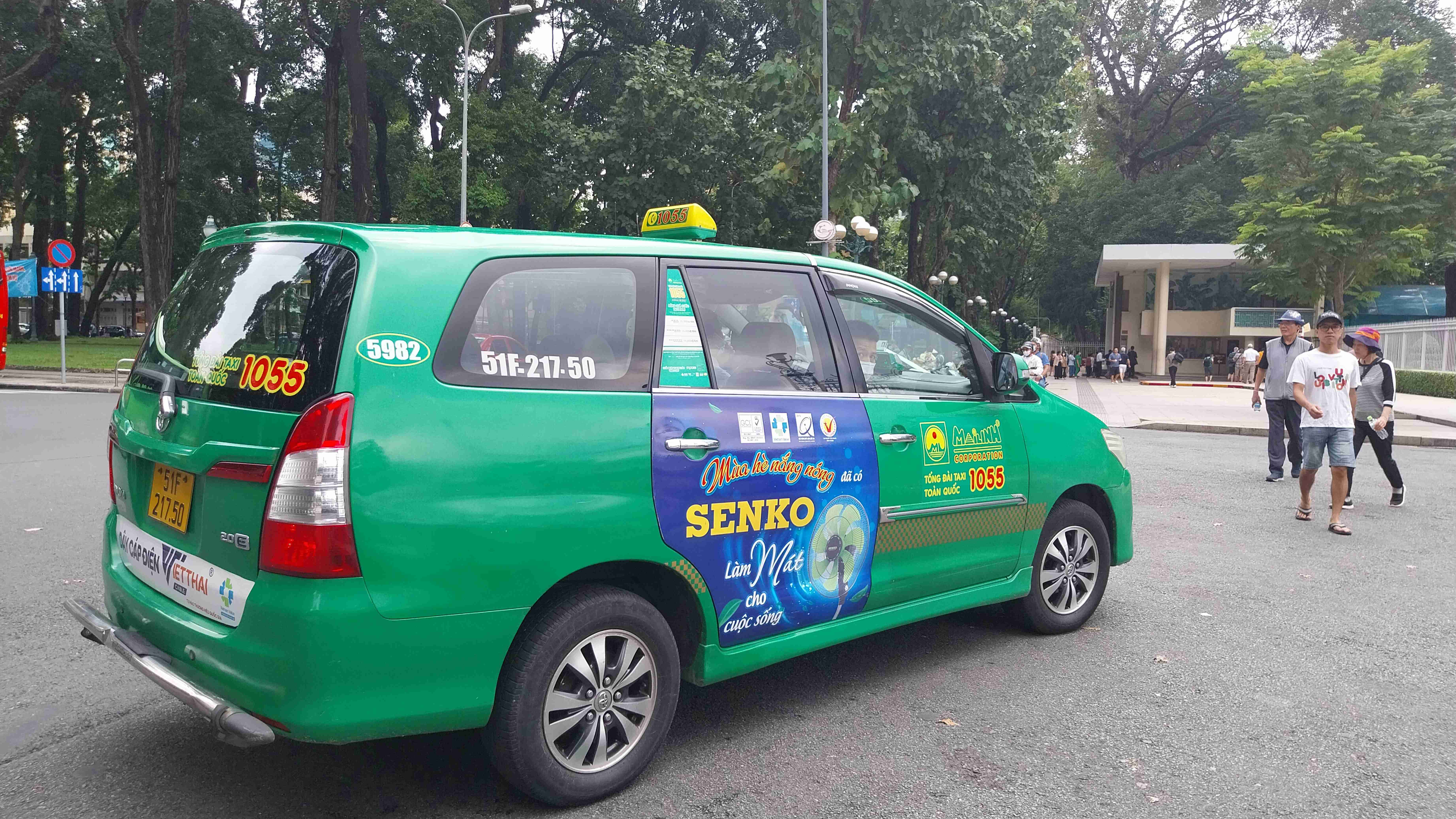 a green car parked on the side of the road