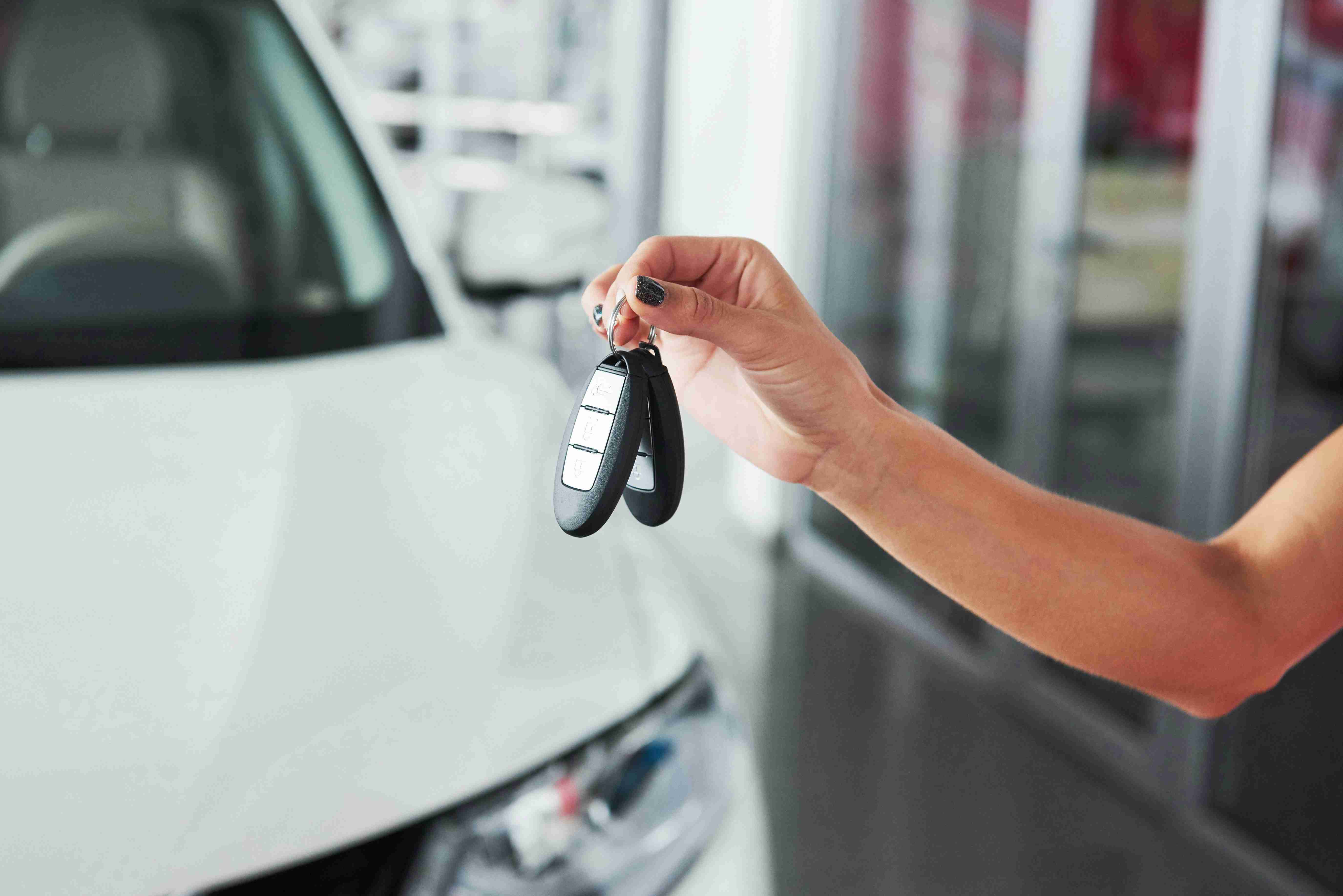 passing-car-keys-cropped-closeup-of-a-car-dealer-holding-out-car-keys