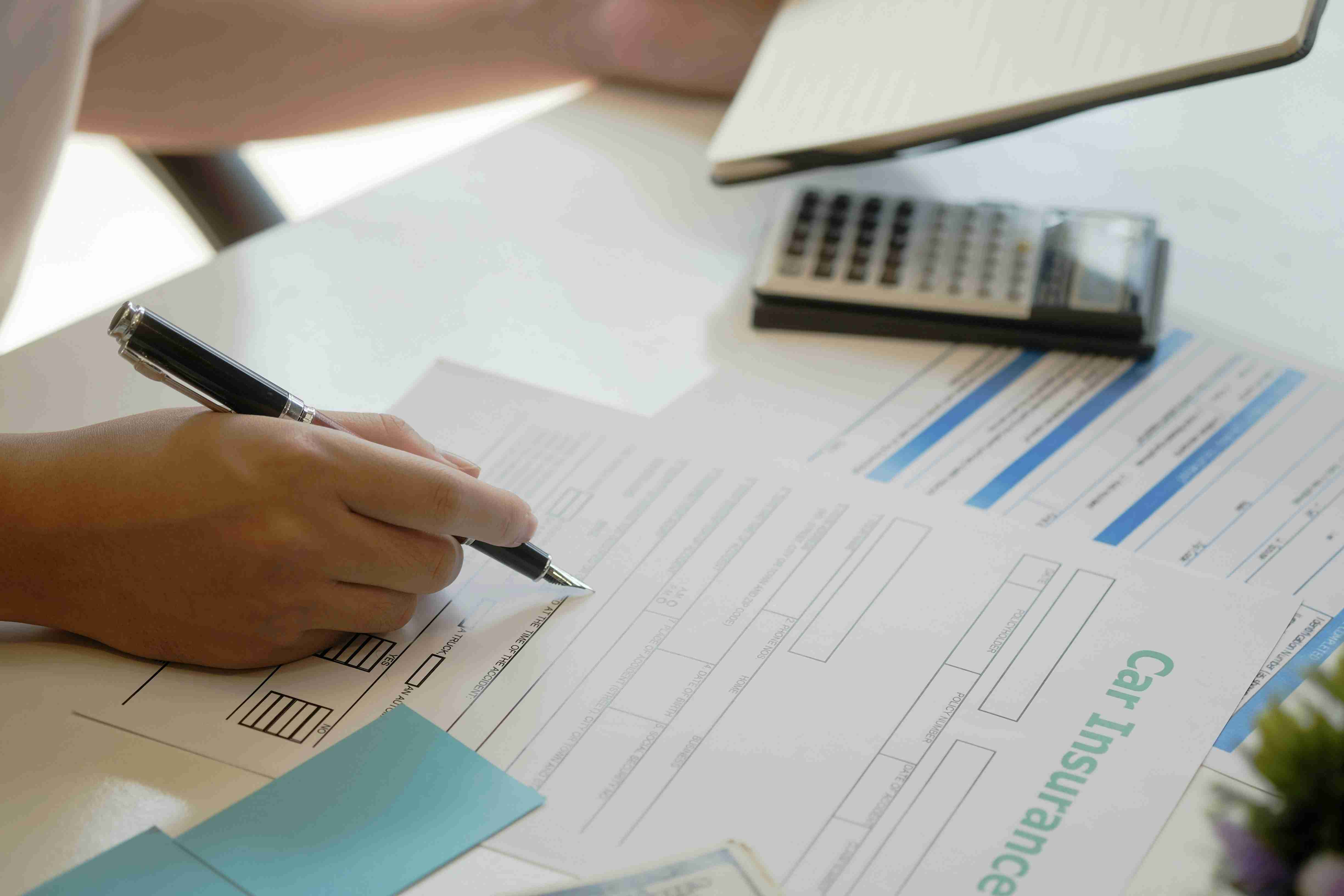 man signs insurance policy