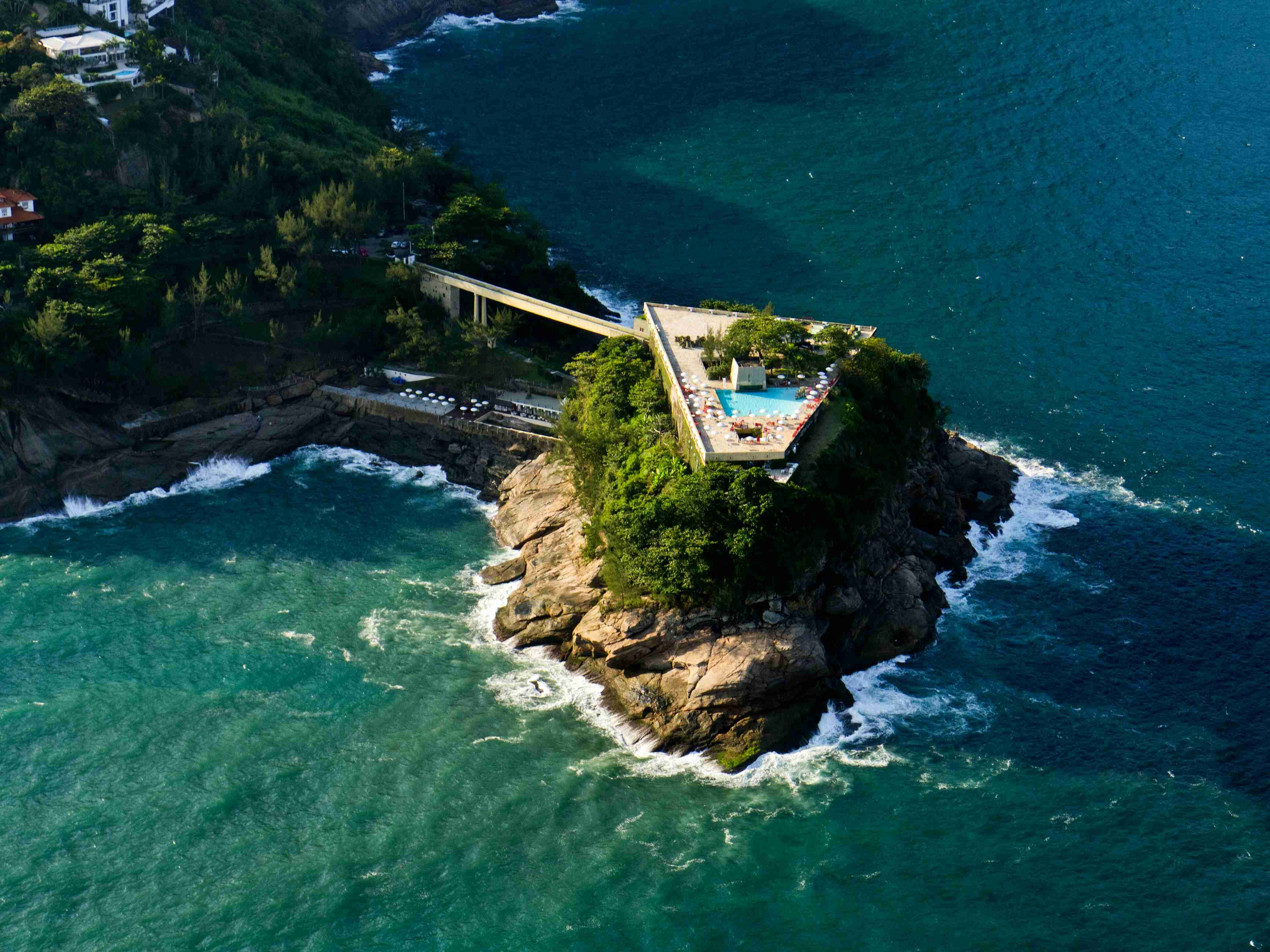 an-aerial-view-of-an-island-with-a-swimming-pool