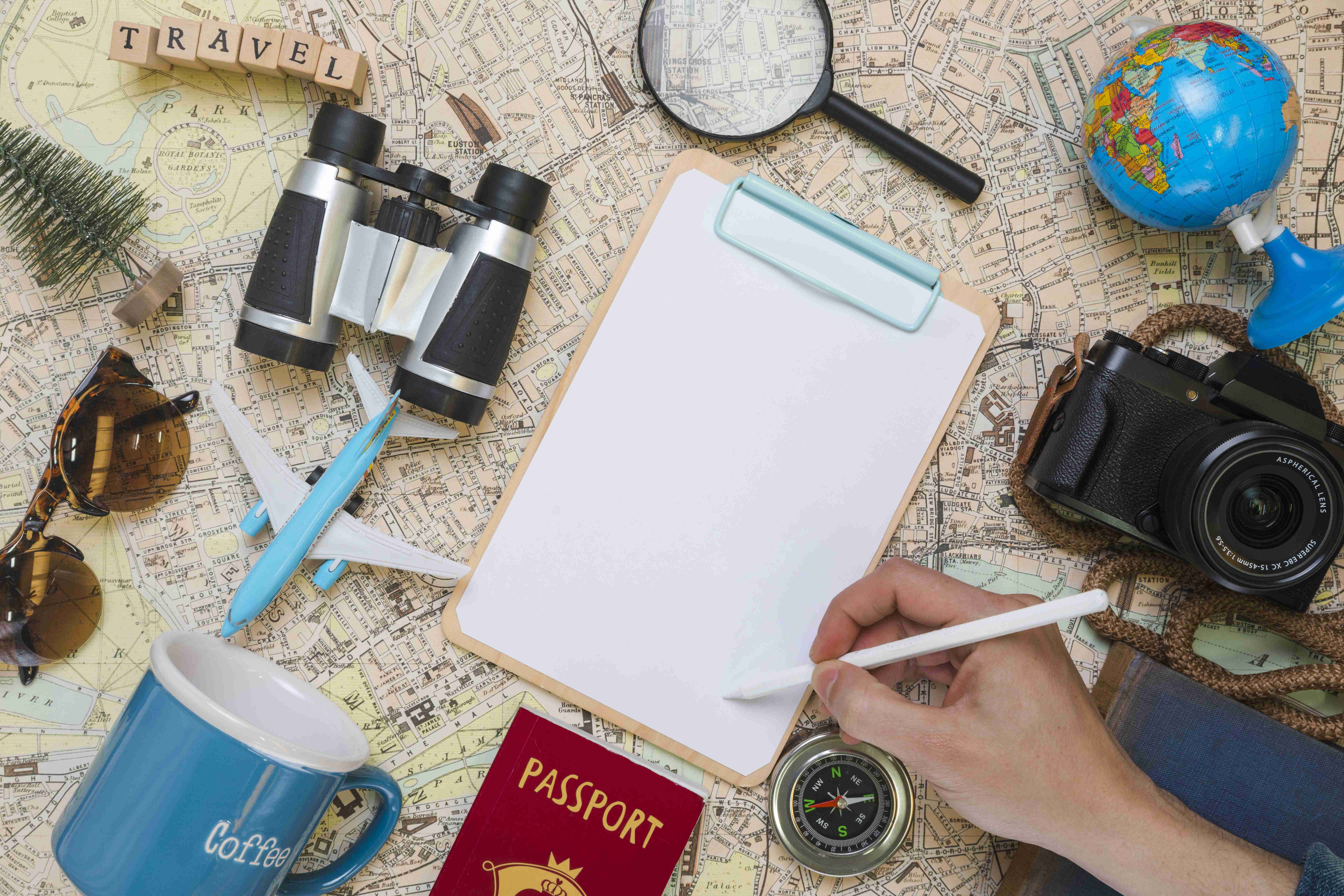 hand writing folder surrounded by travel elements