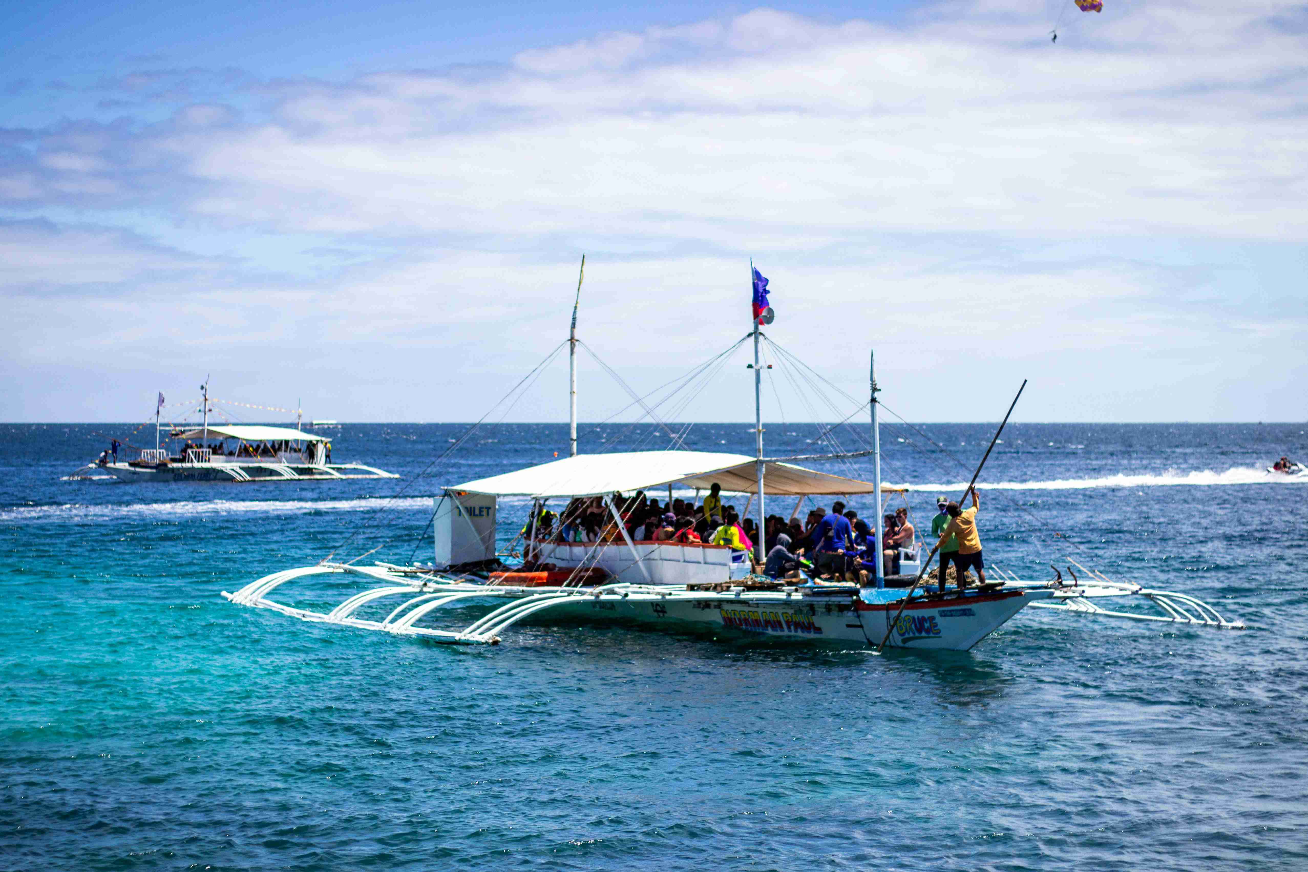 blue and white boat on sea