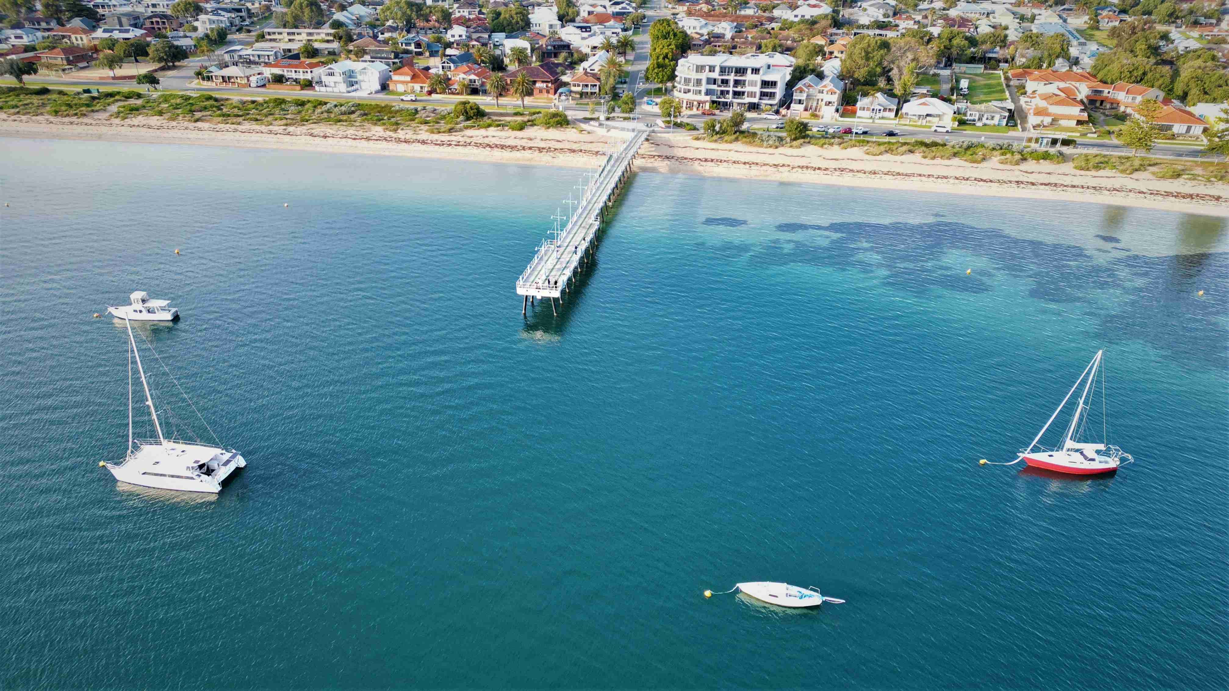 a-couple-of-boats-floating-on-top-of-a-body-of-water