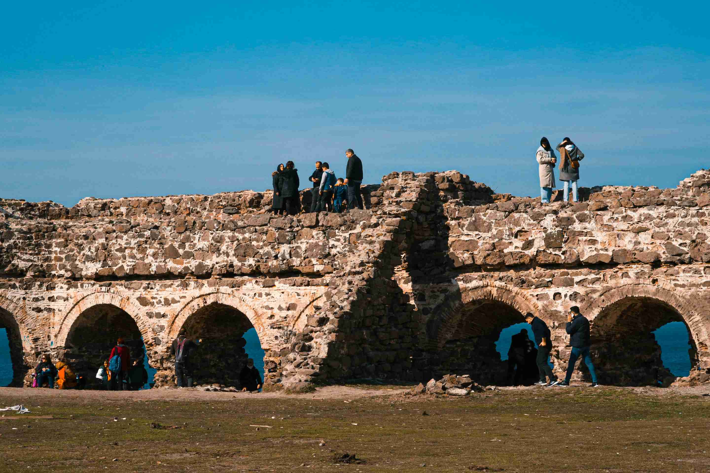 a-group-of-people-standing-on-a-stone-structure