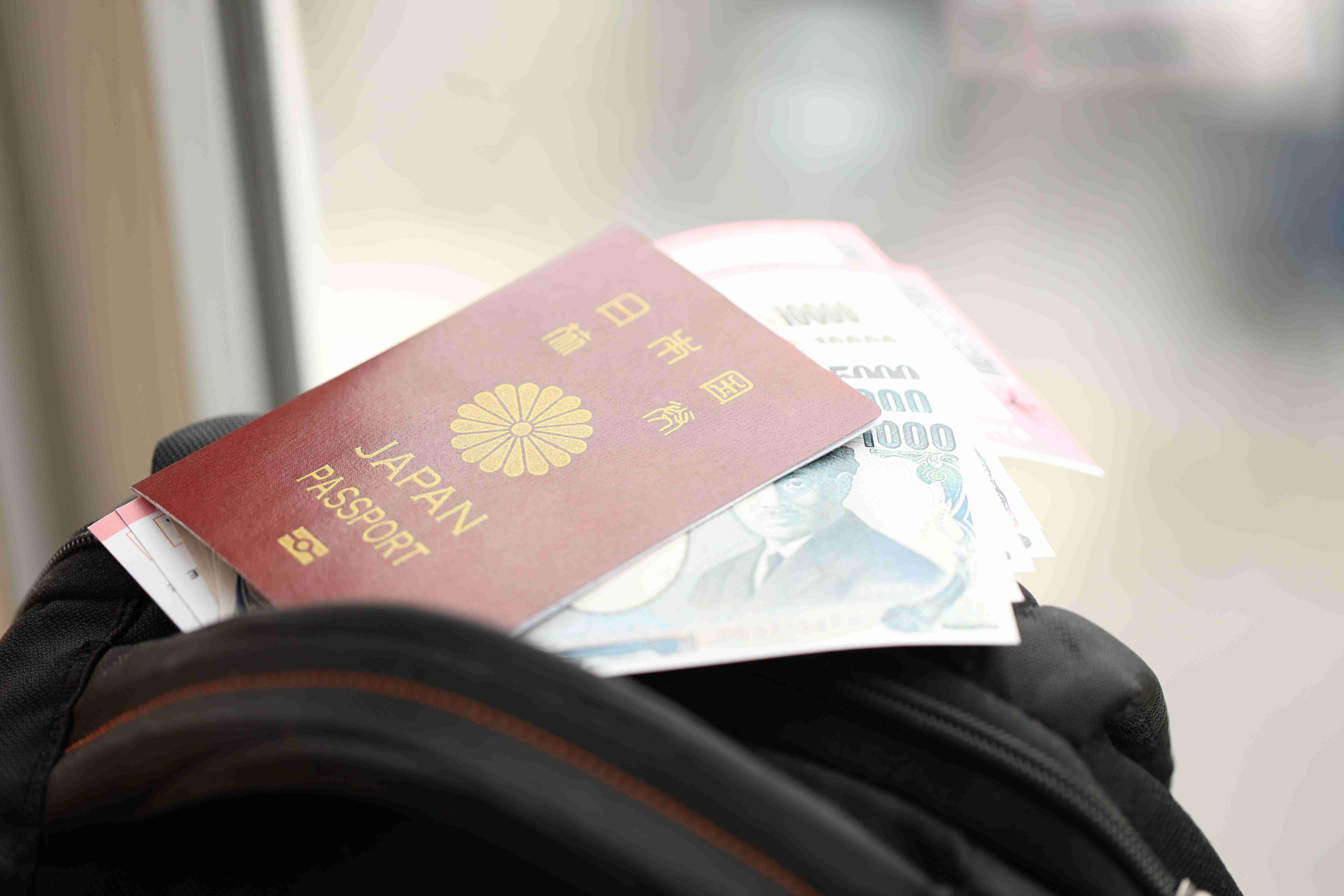 Japan passport with japanese yen money bills