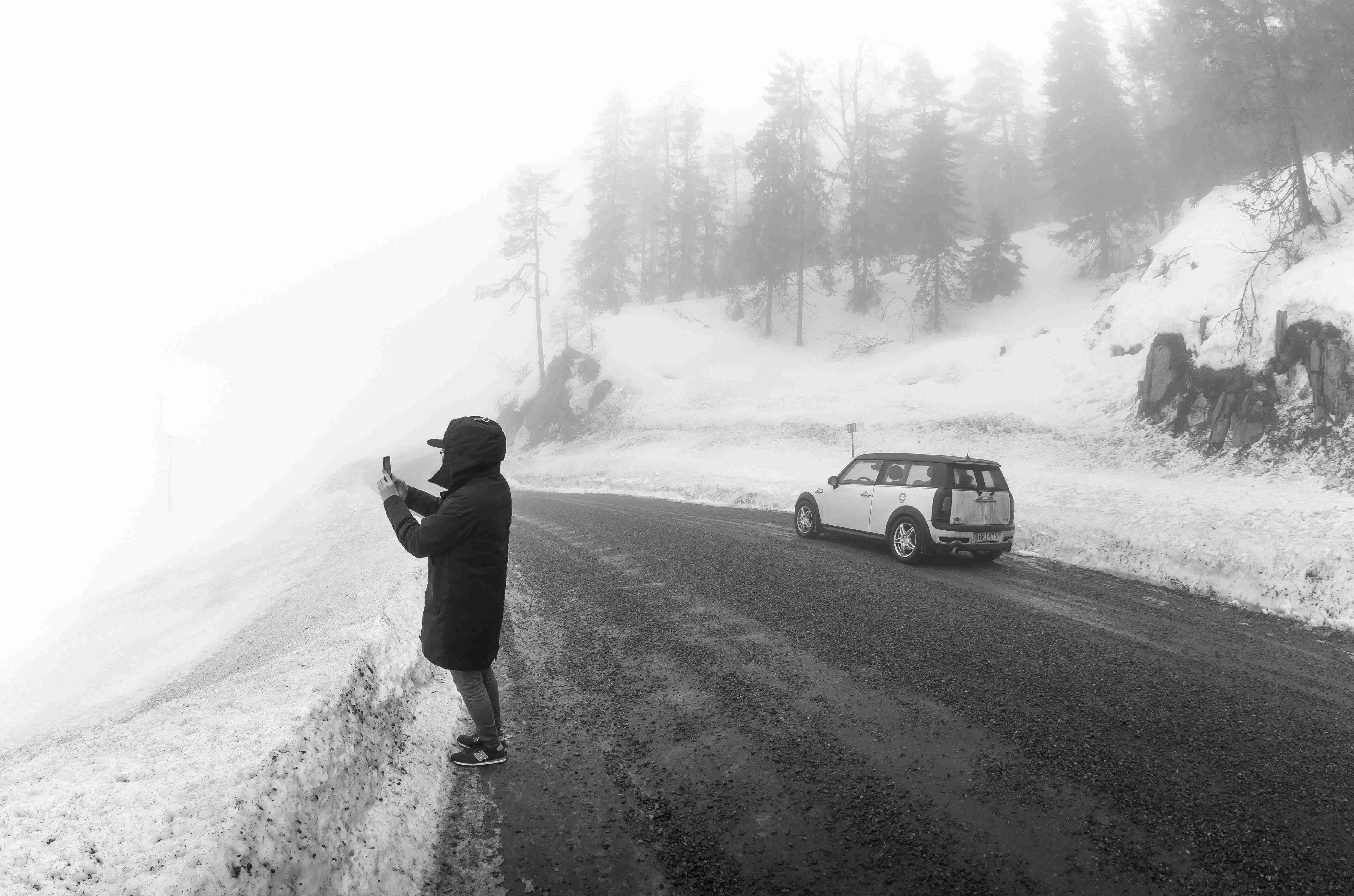 काले जैकेट और पैंट में आदमी सड़क पर खड़ा है