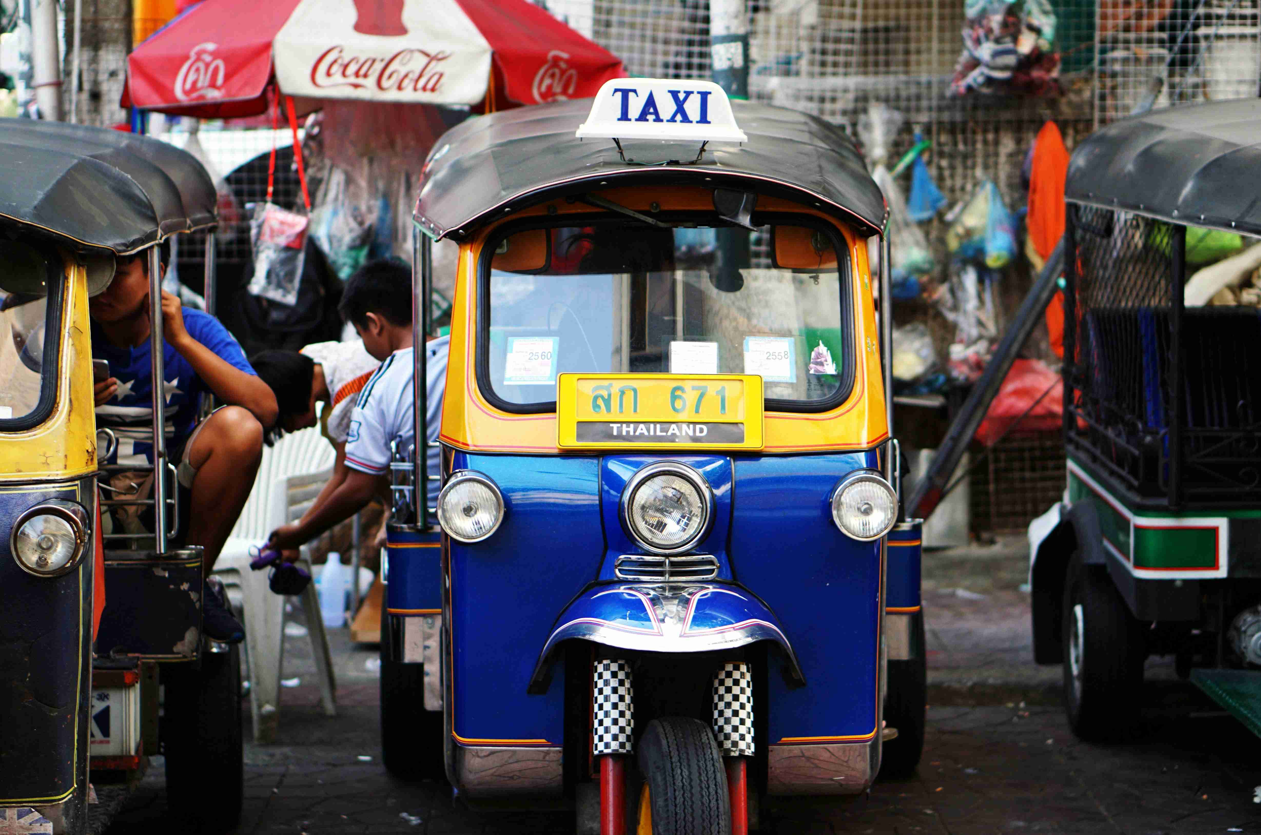 yellow and blue auto rickshaw