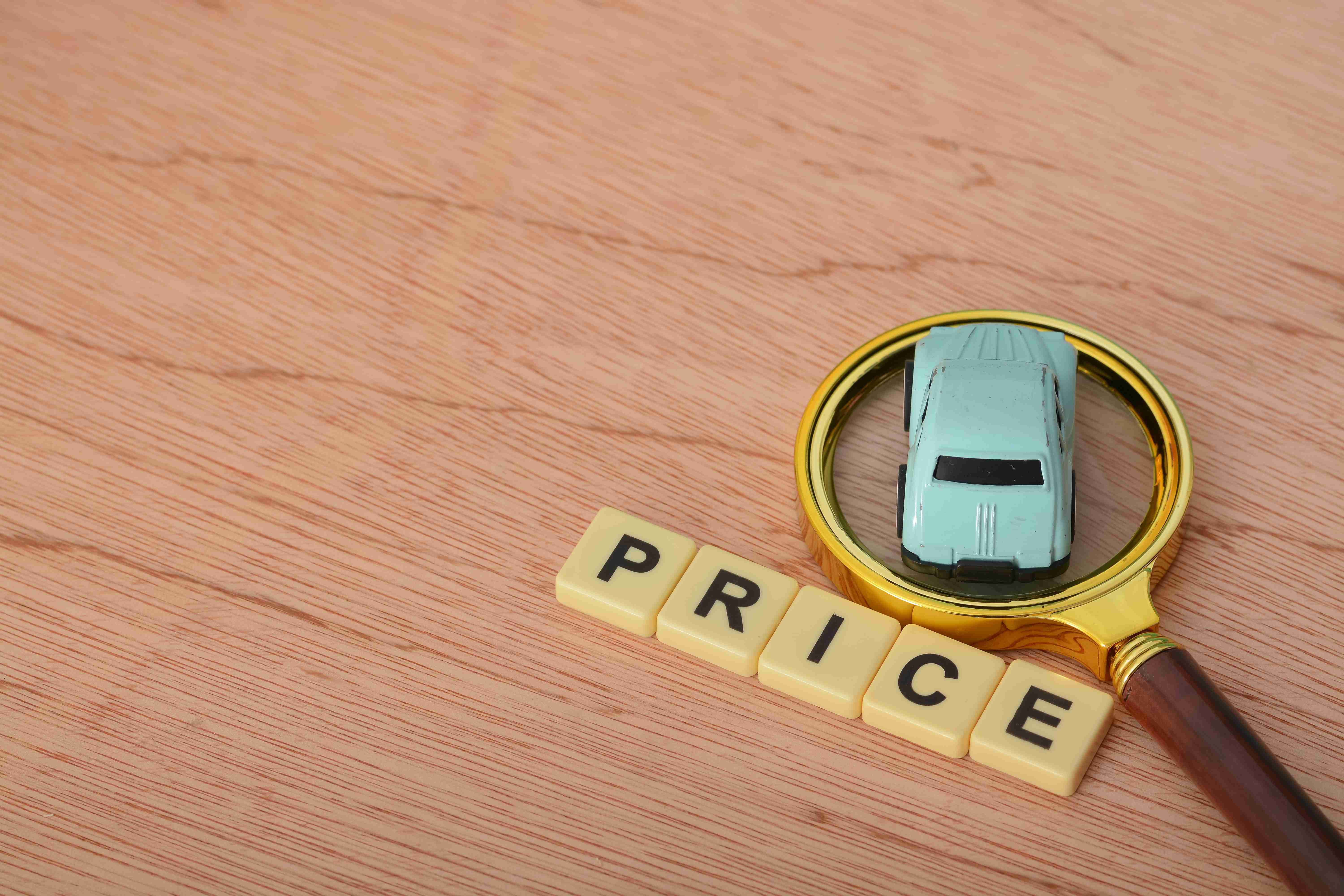 Magnifying glass and car with text PRICE