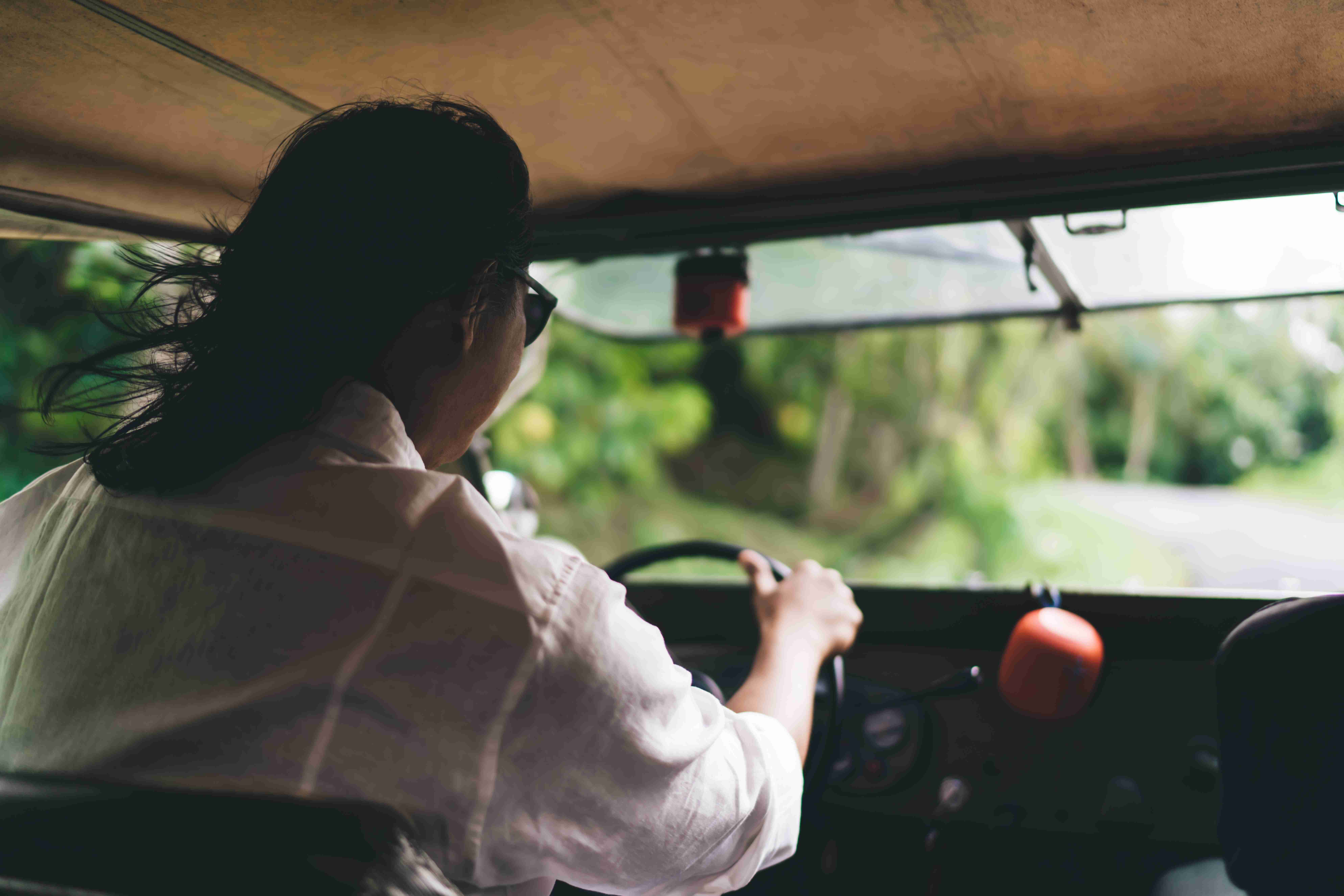 Man driving car in countryside on summer