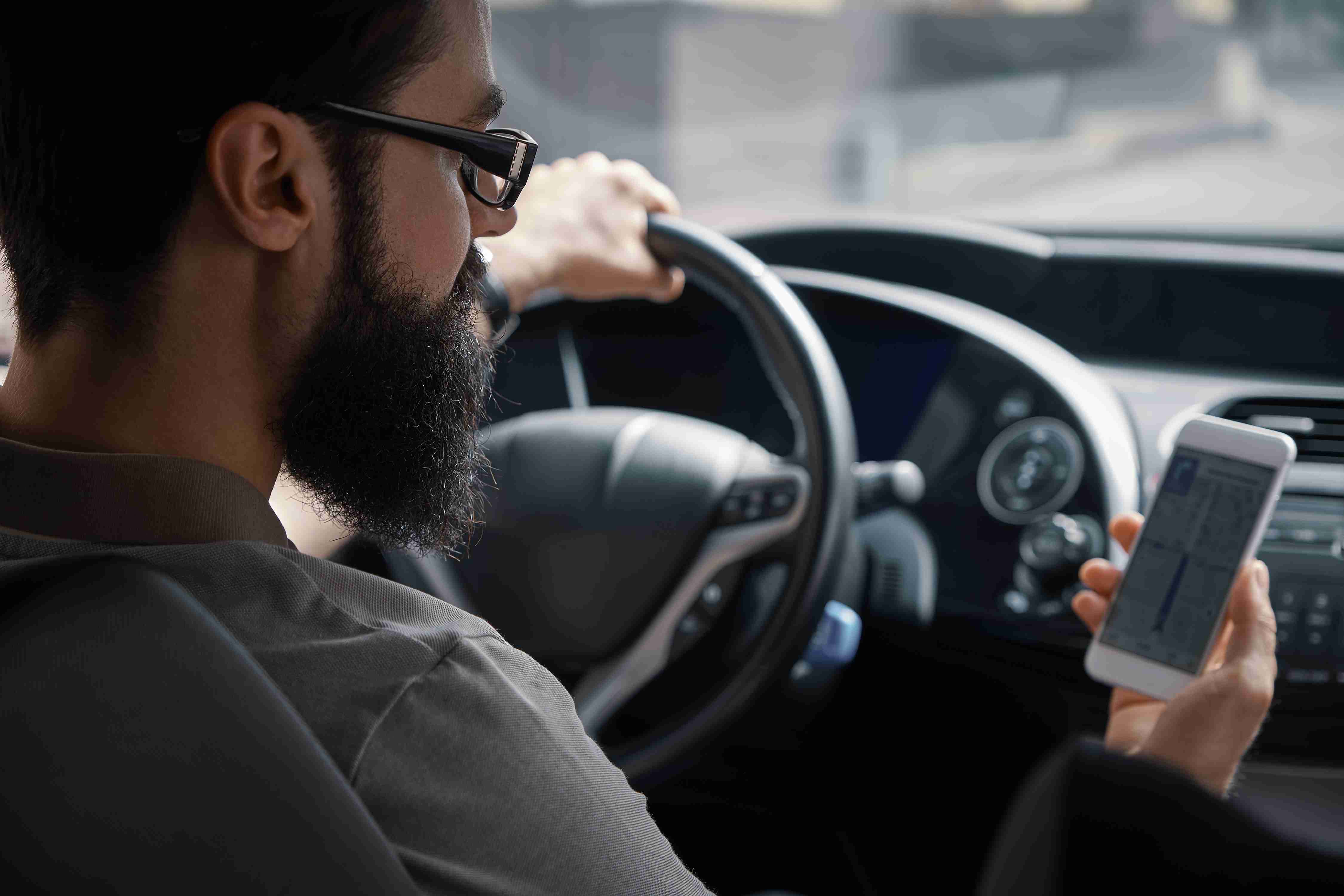 man using mobile phone while driving
