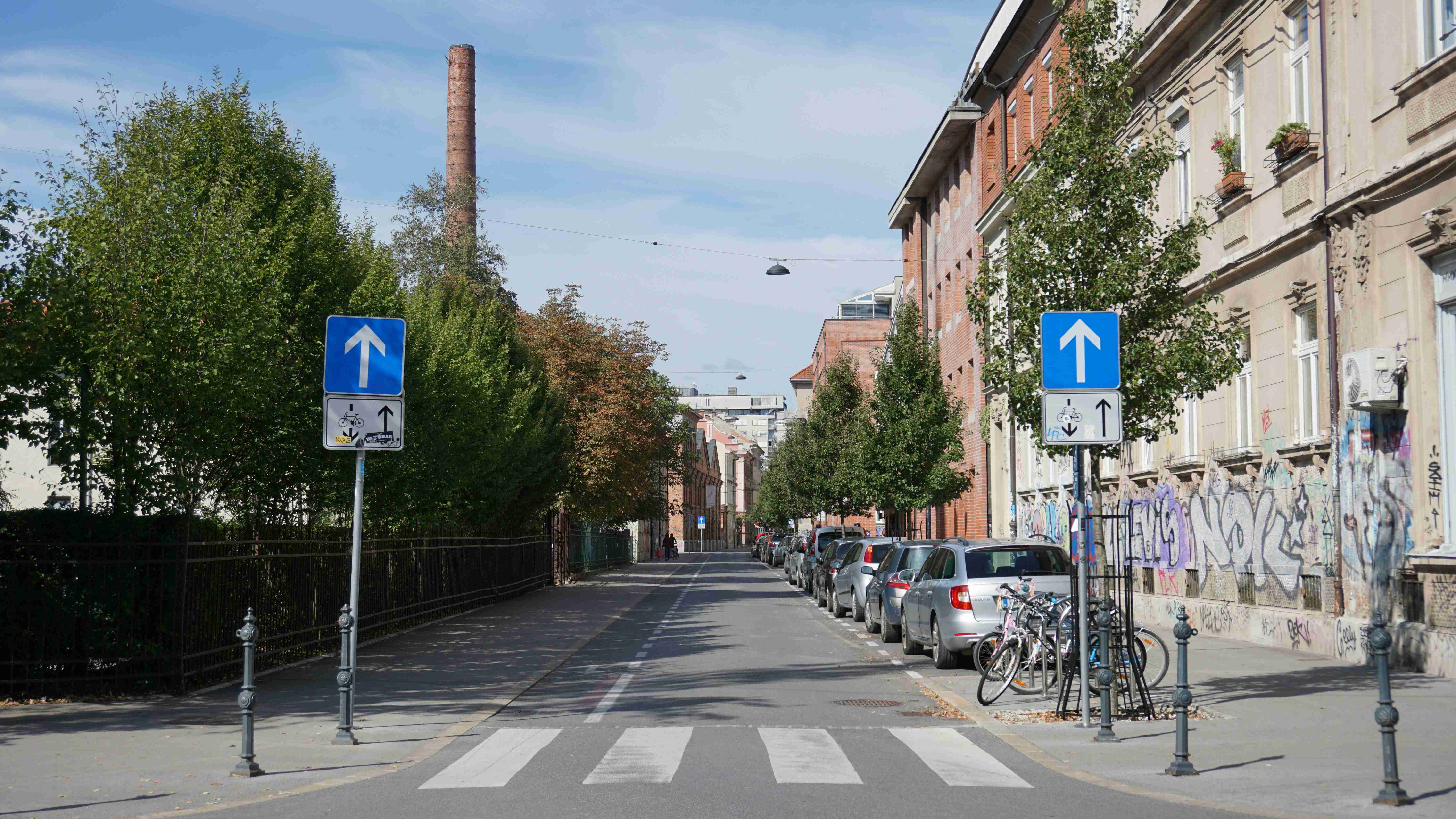 a street with several cars parked on the side of it