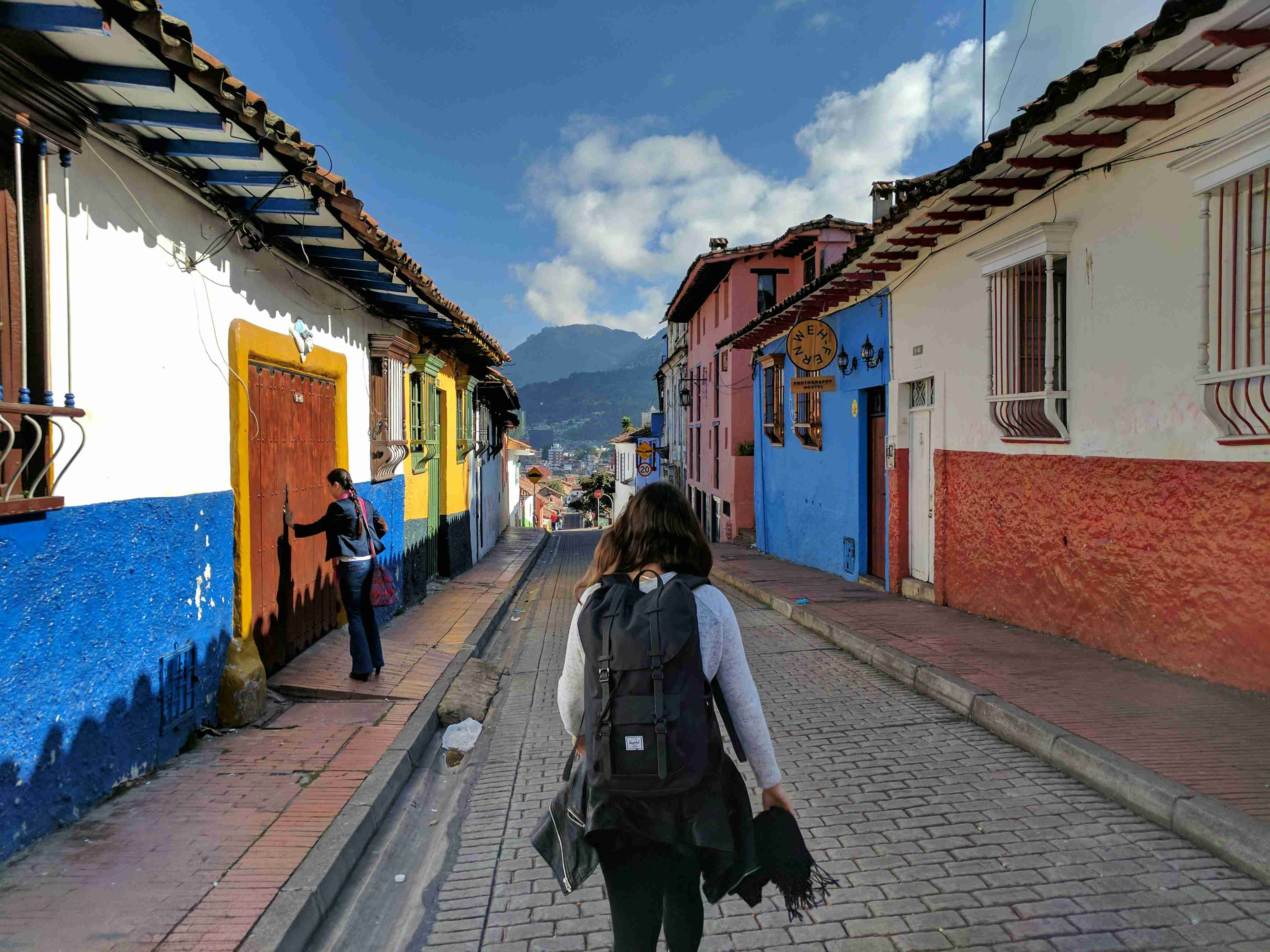 person-in-gray-shirt-with-backpack-walking-on-street
