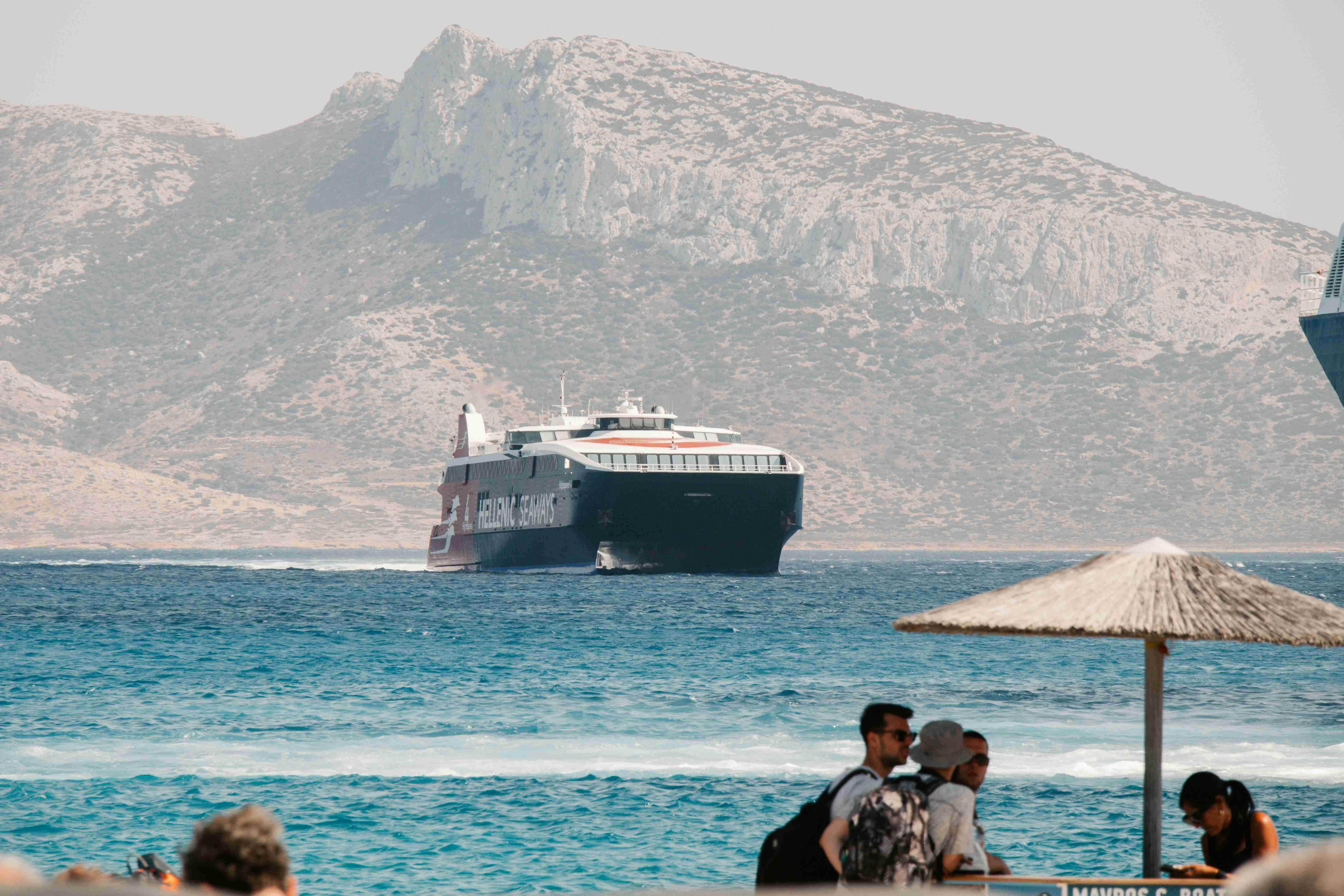 a cruise ship in the water near a beach